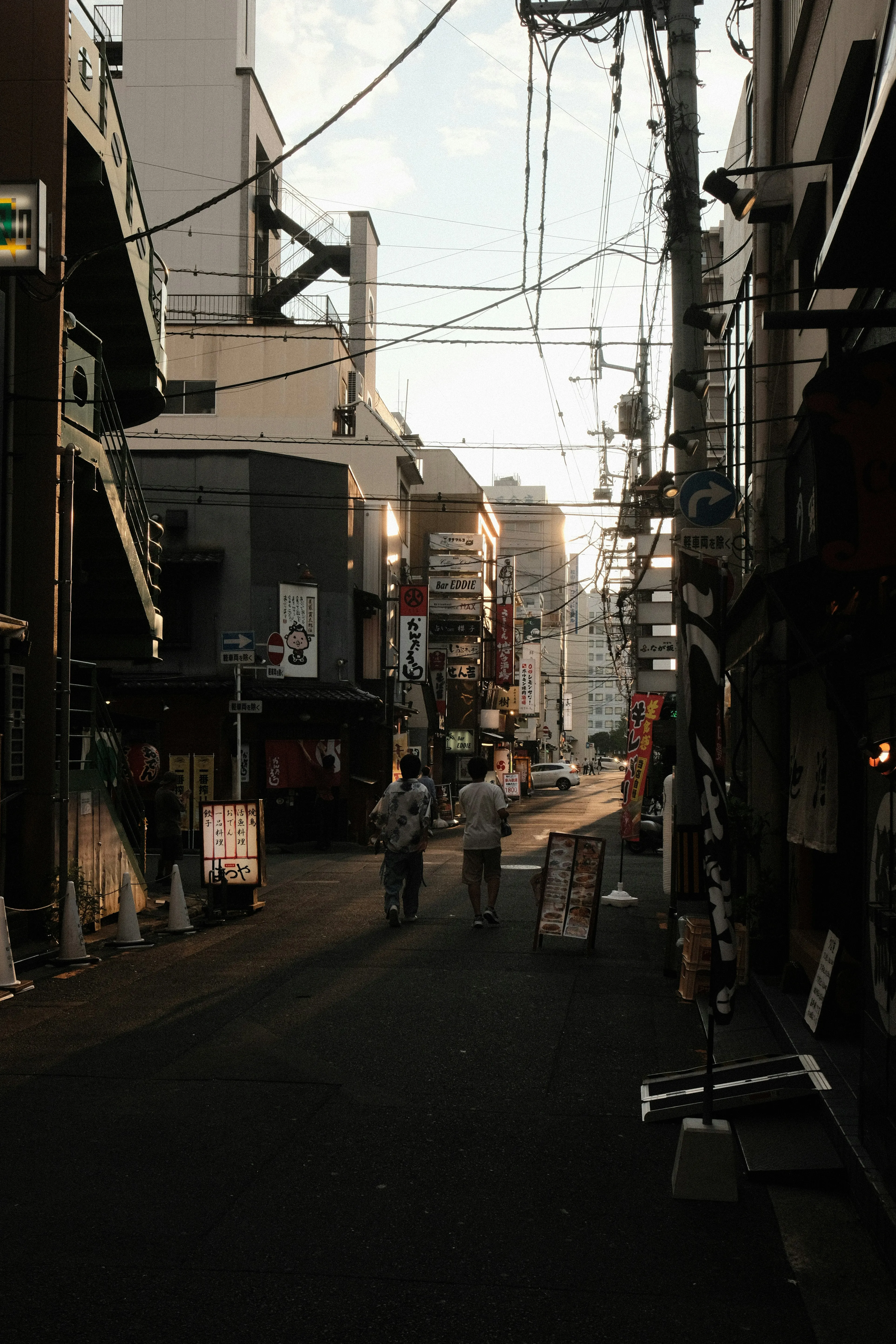 Evocative Street Photography: Urban Alleyway with Overhead Wires
