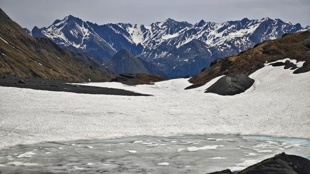 Majestic Alpine Panorama: Frozen Lake & Snowy Peaks