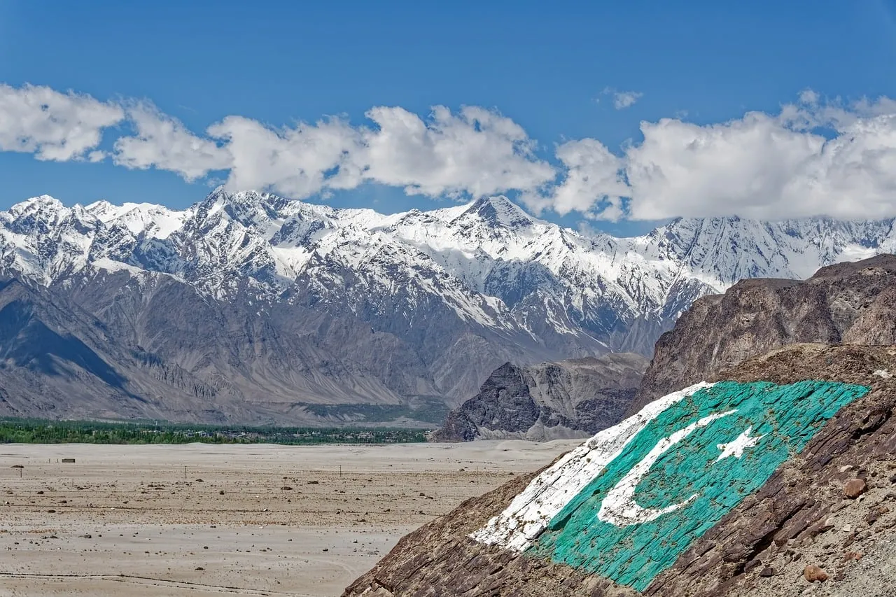 Majestic Karakoram: Pakistan Flag Adorns Snow-Capped Peaks