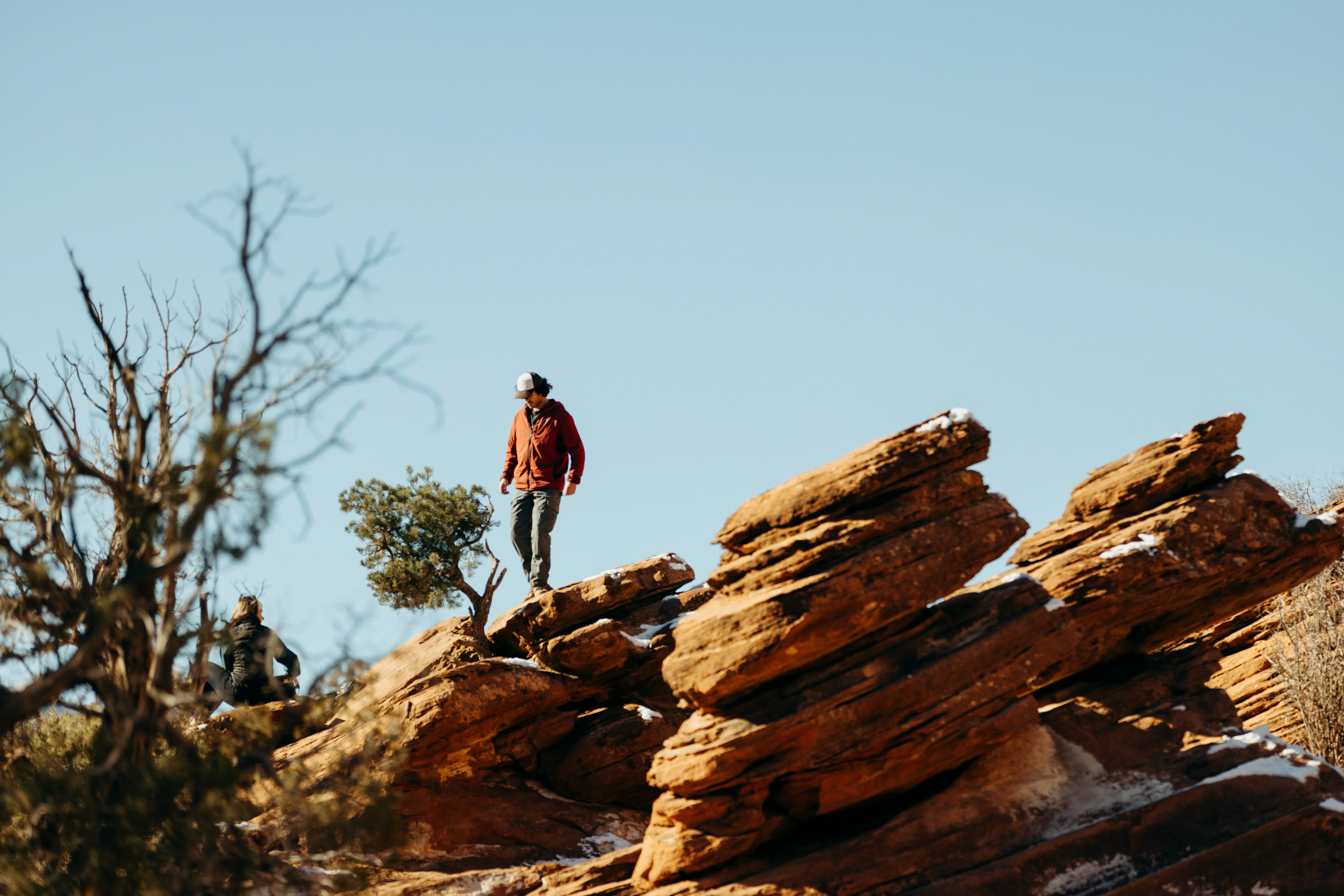 Rugged Ascent: Hiker Explores Rocky Terrain Under Clear Sky
