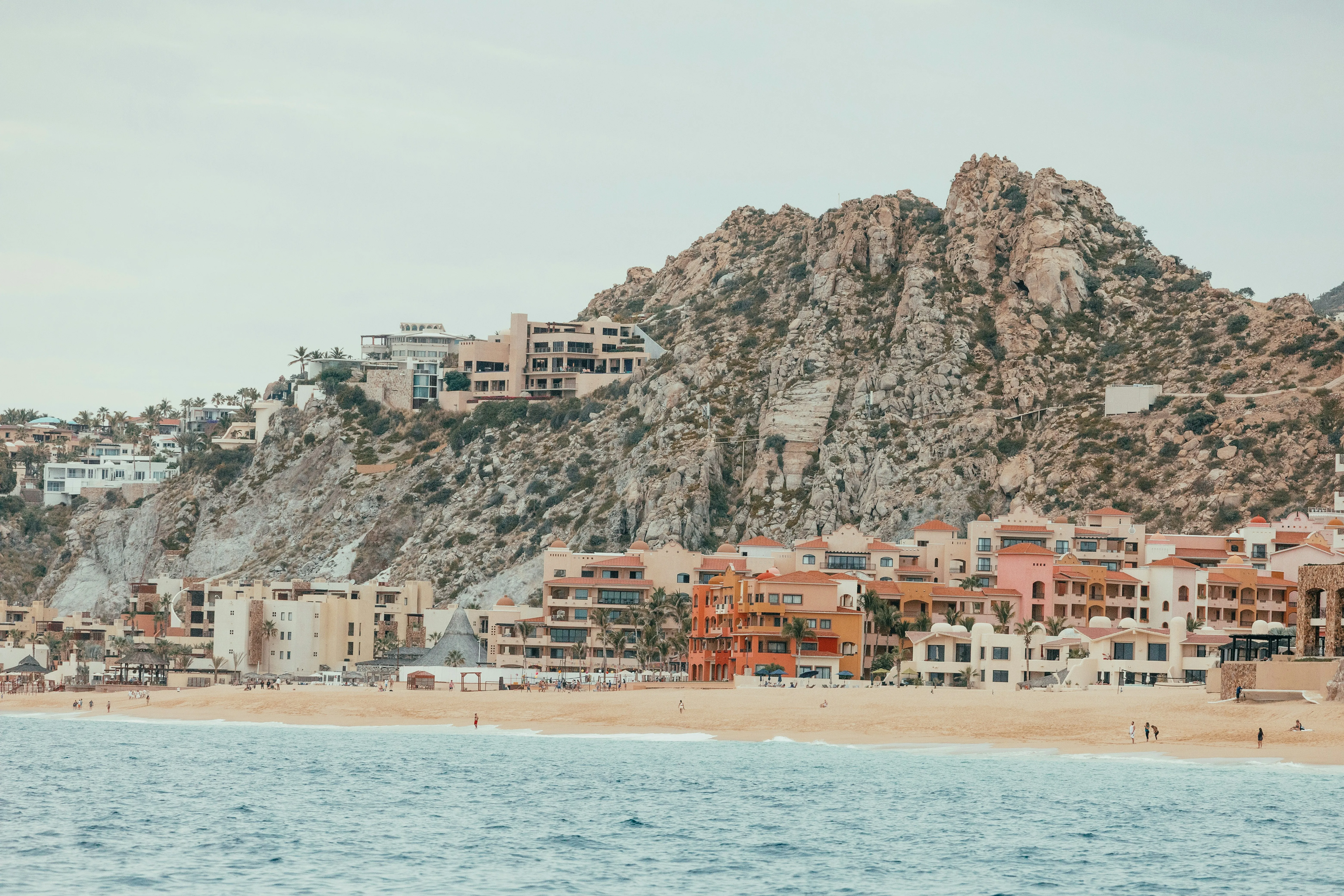 Vibrant Coastal Escape: Colorful Buildings Under Rocky Mountains