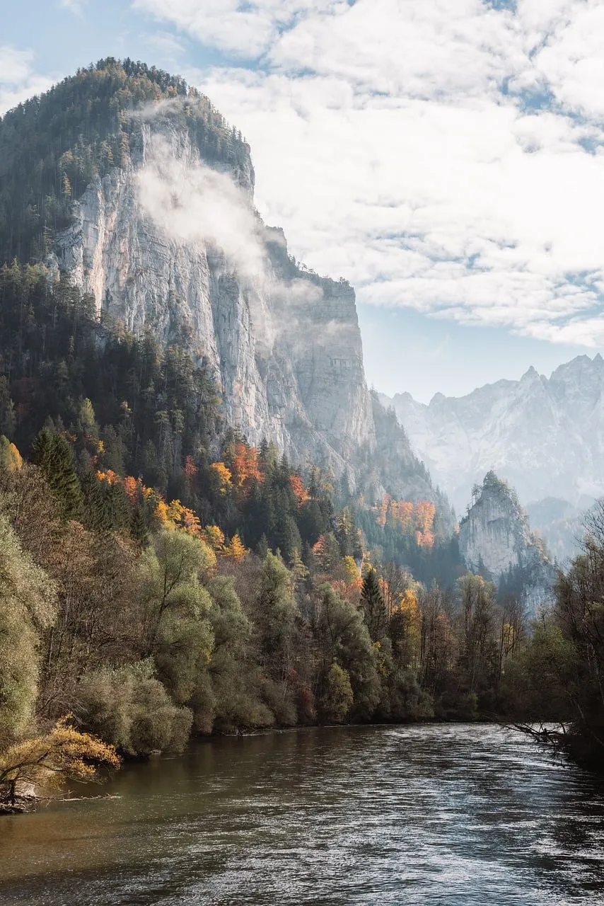 Breathtaking Austrian Alpine River Valley in Autumn Mist