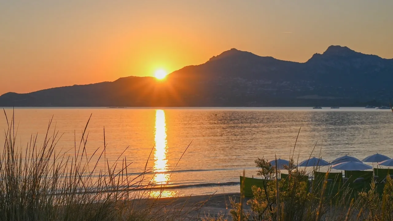 Breathtaking Corsica Sunrise: Golden Glow Over Tranquil Bay