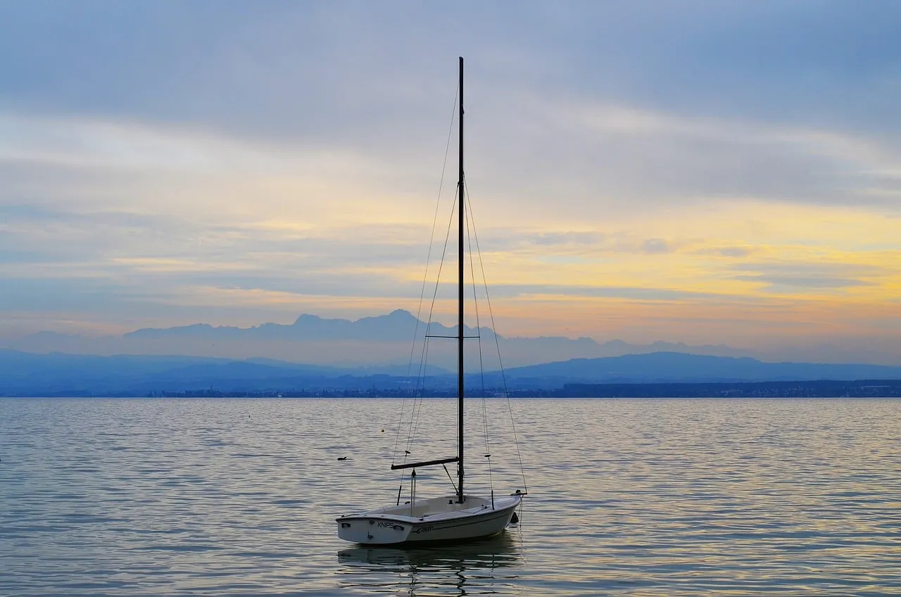 Serene Sunset Sailboat on Tranquil Lake Waters