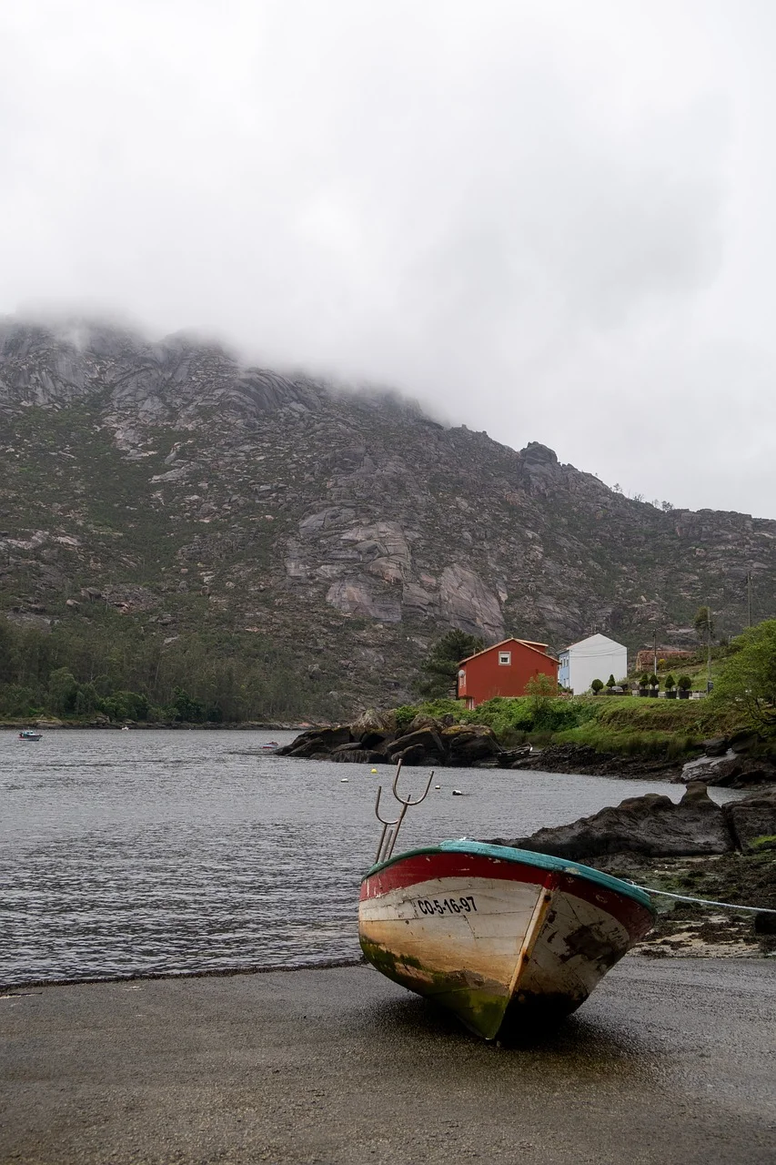 Serene Coastal Retreat: A Fishing Boat on a Misty Shore