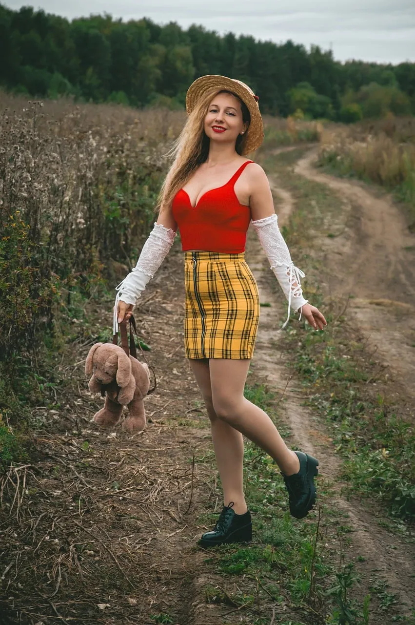 Charming Blonde in Autumn Field: Eclectic Fashion & Rural Serenity