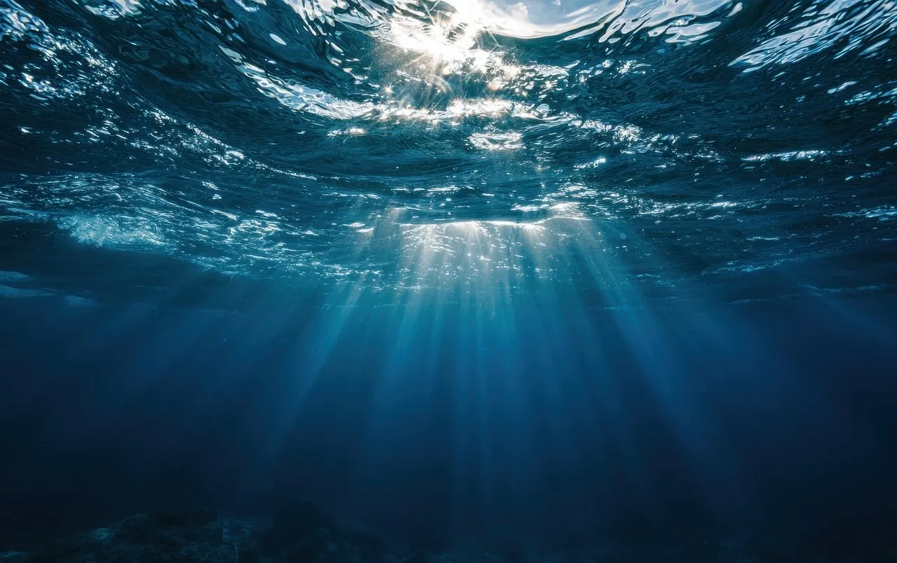 Sublime Underwater Serenity: Light Rays Piercing Deep Blue Waves