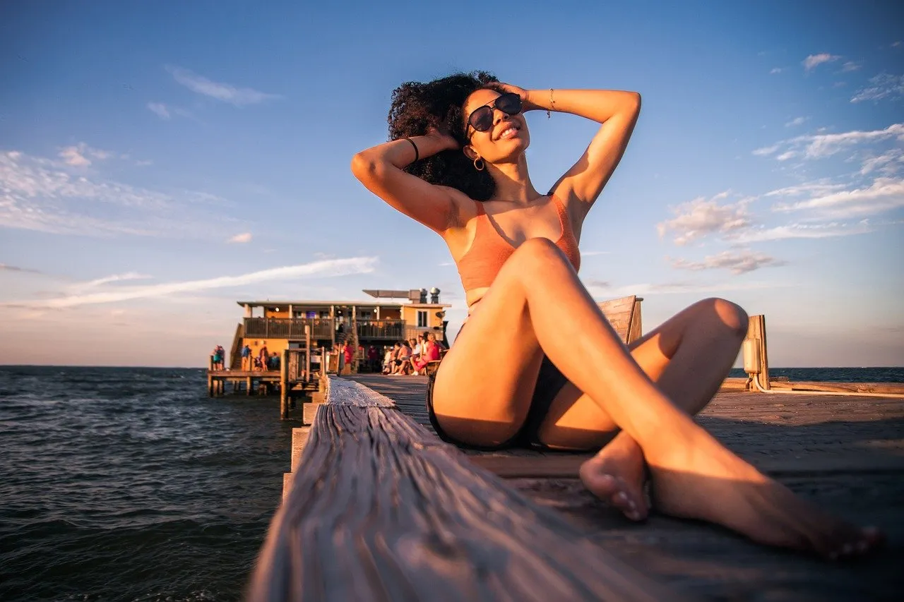Stunning Sunset Serenity: Woman Relaxing on a Coastal Pier