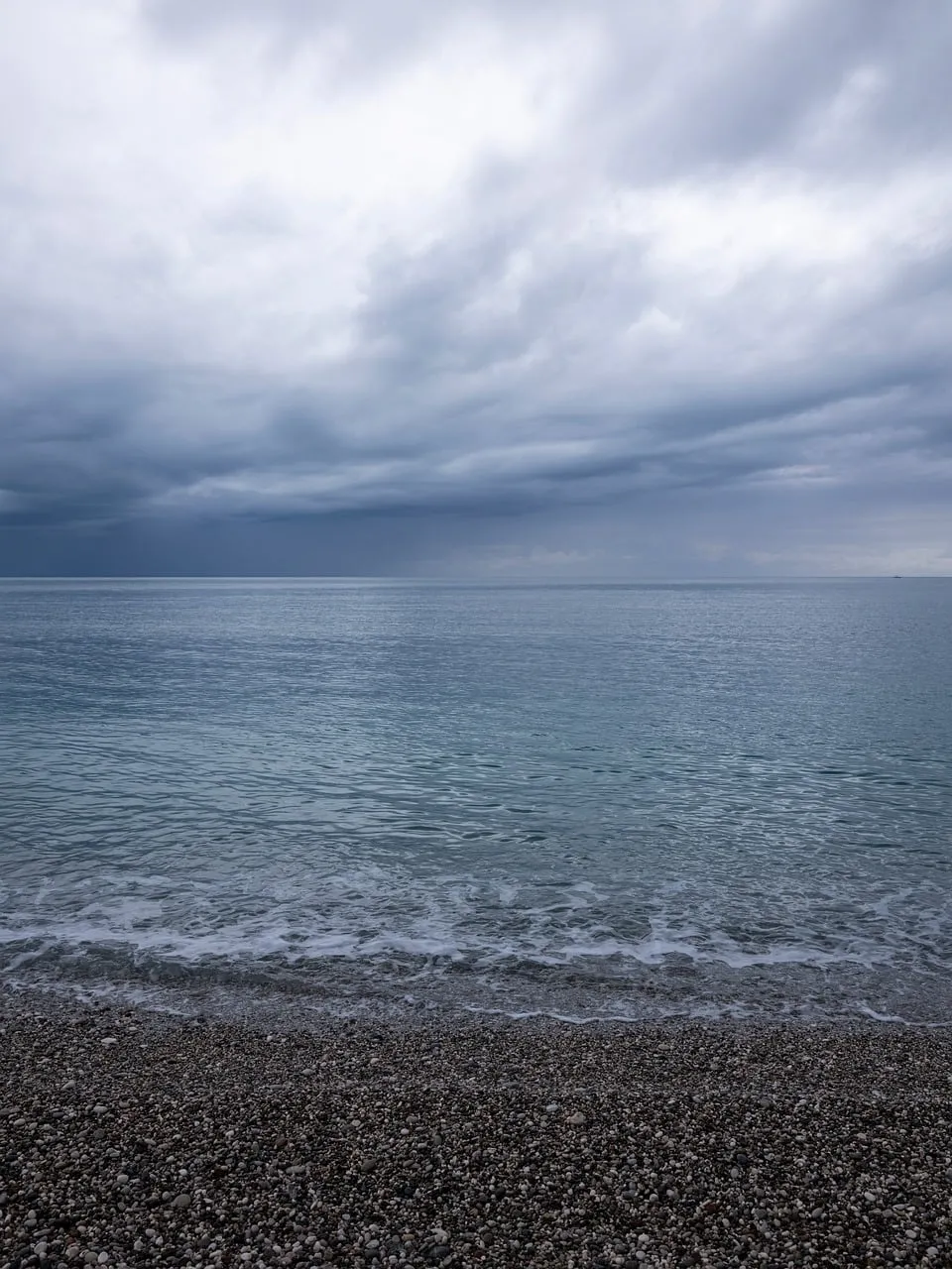 Serene Pebble Beach Under a Dramatic Grey Sky