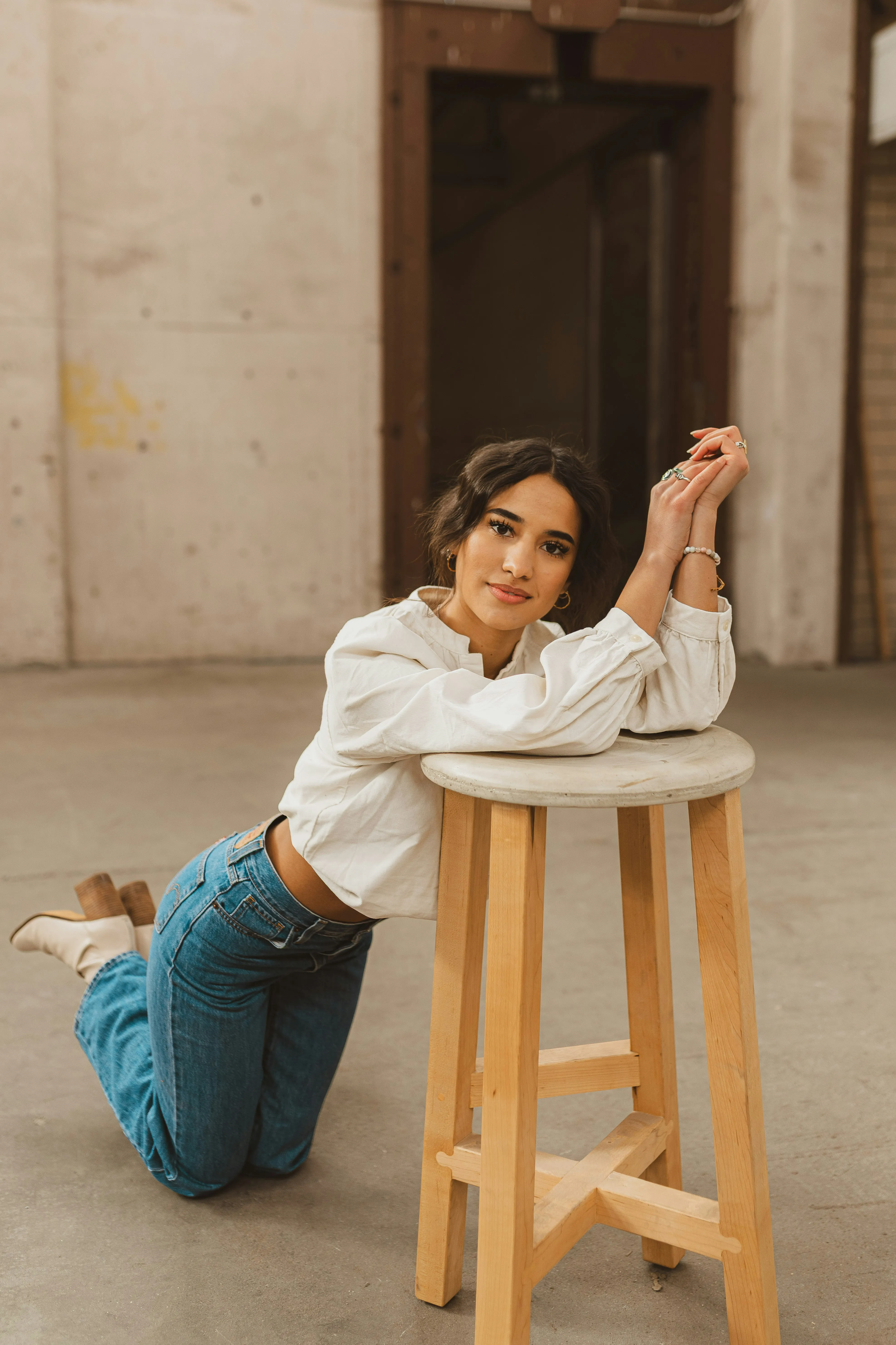 Charming Casual: Young Woman Posing on Stool