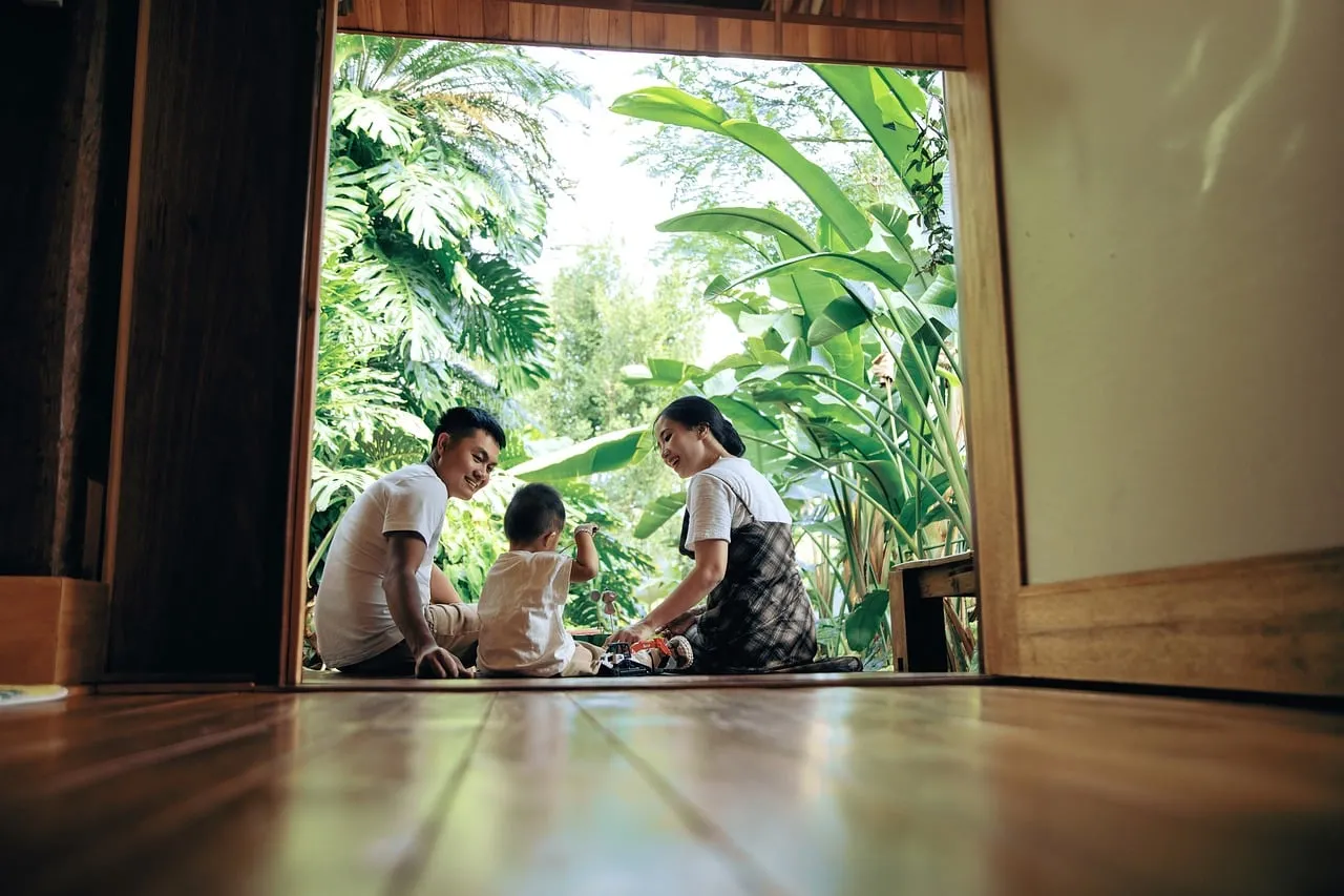 Joyful Family Moment: Parents & Child Embrace Nature's Bliss