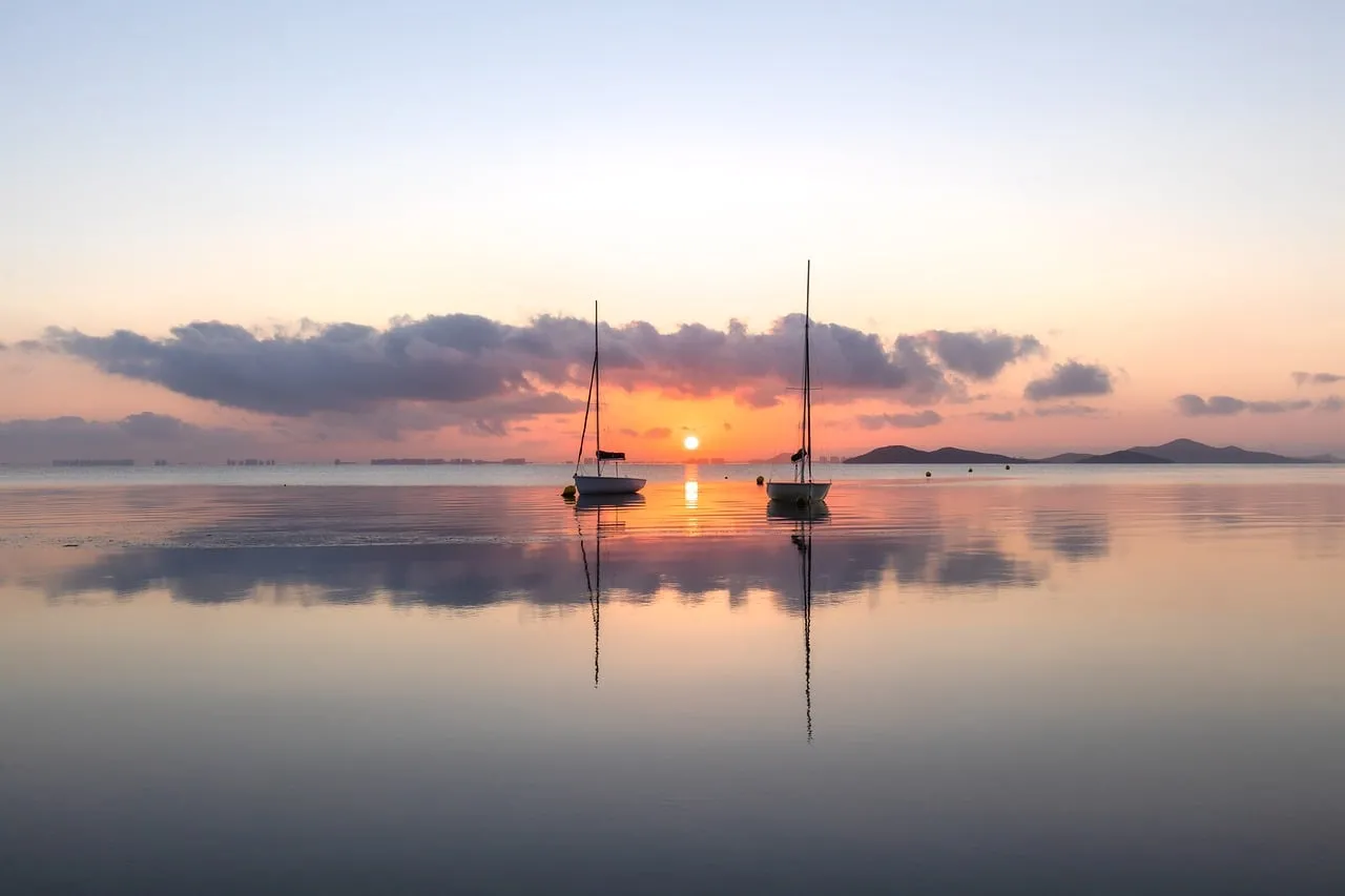 Serene Dawn: Two Boats Reflecting the Murcia Sunrise