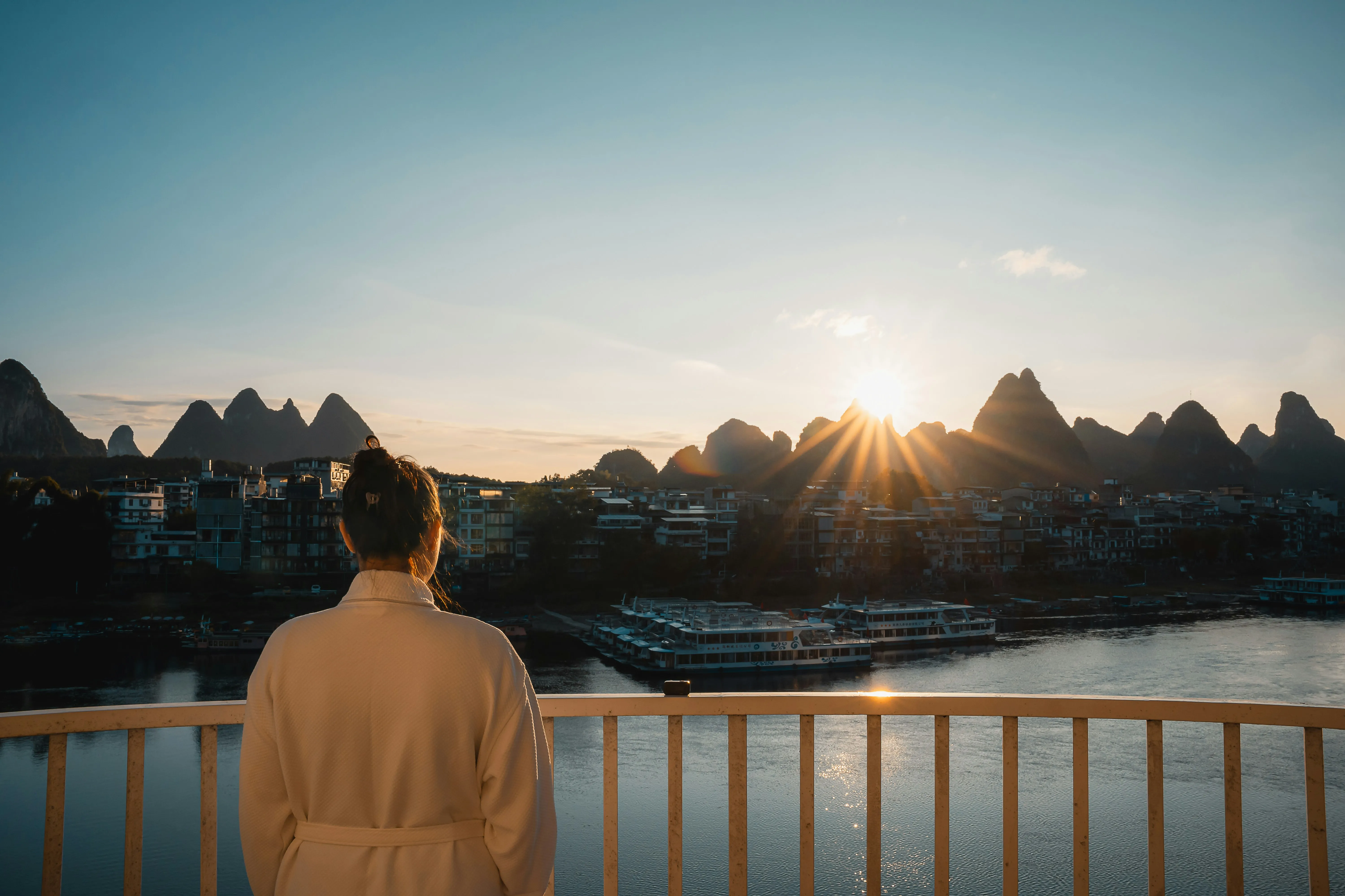 Breathtaking Karst Sunrise: Woman Admires Majestic Scenery