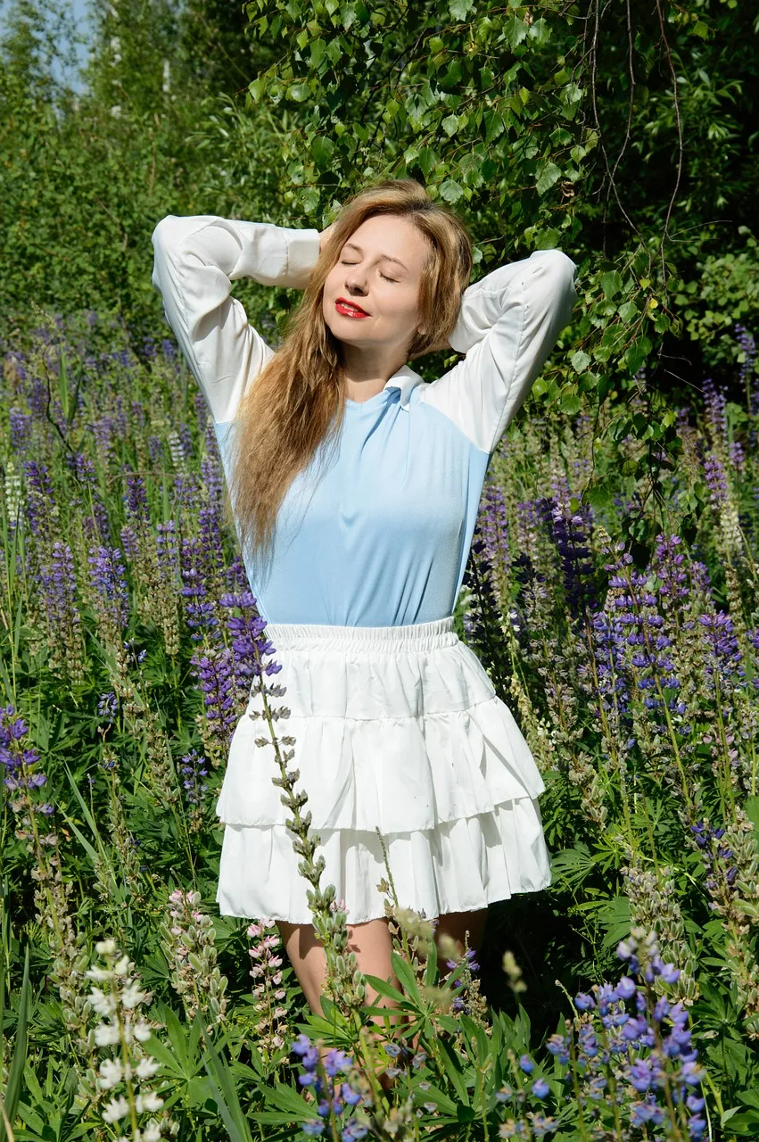 Joyful Woman Embracing Nature in a Lush Lupine Meadow