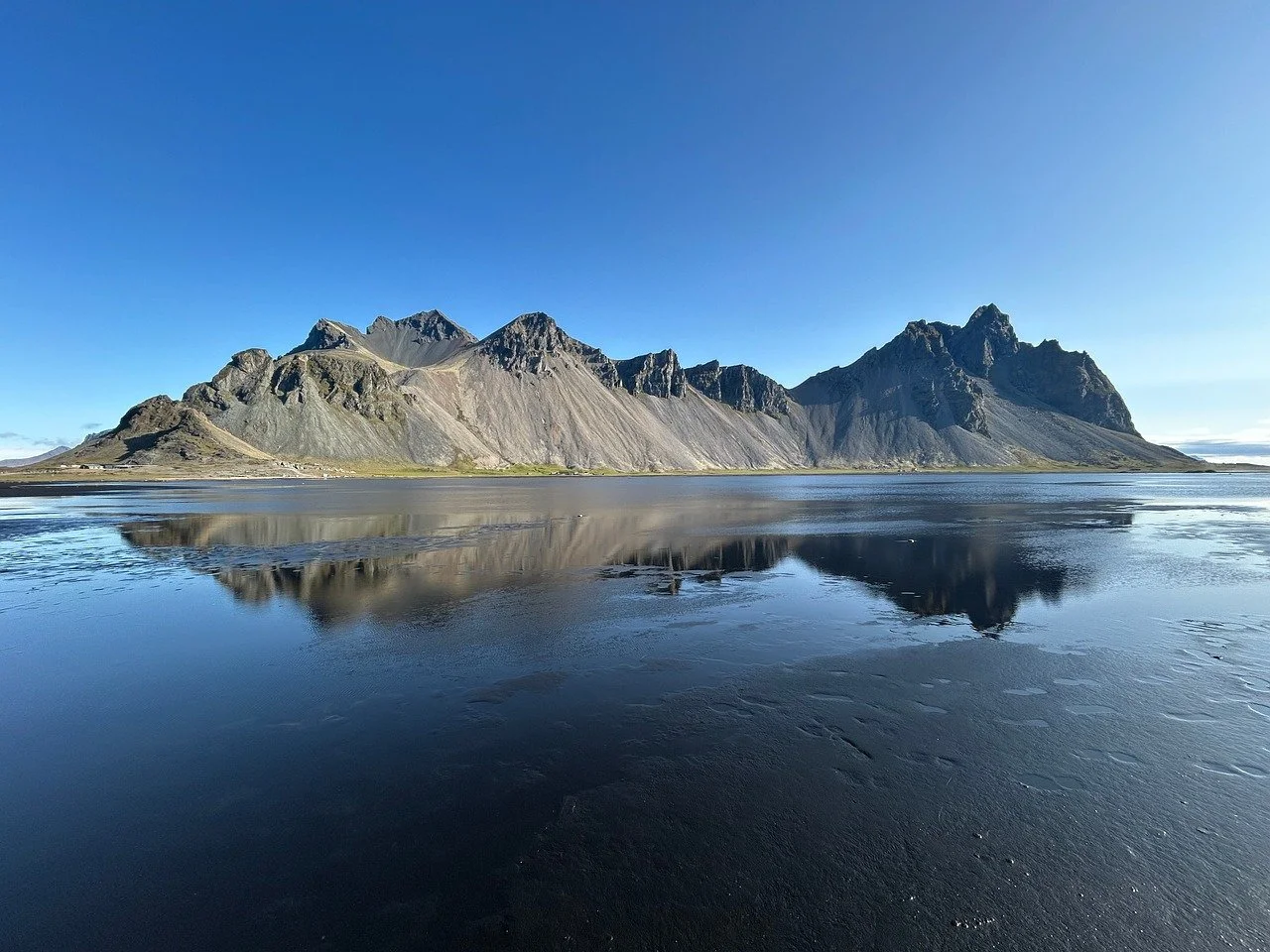 Dramatic Vestrahorn Peaks Reflected on Iceland's Black Sand Beach