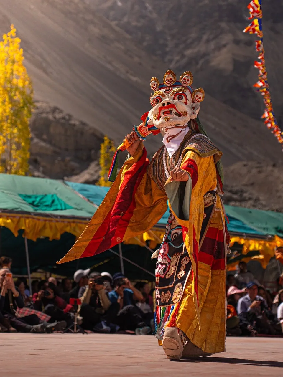 Vibrant Himalayan Dance: Masked Performer in Mountain Festival