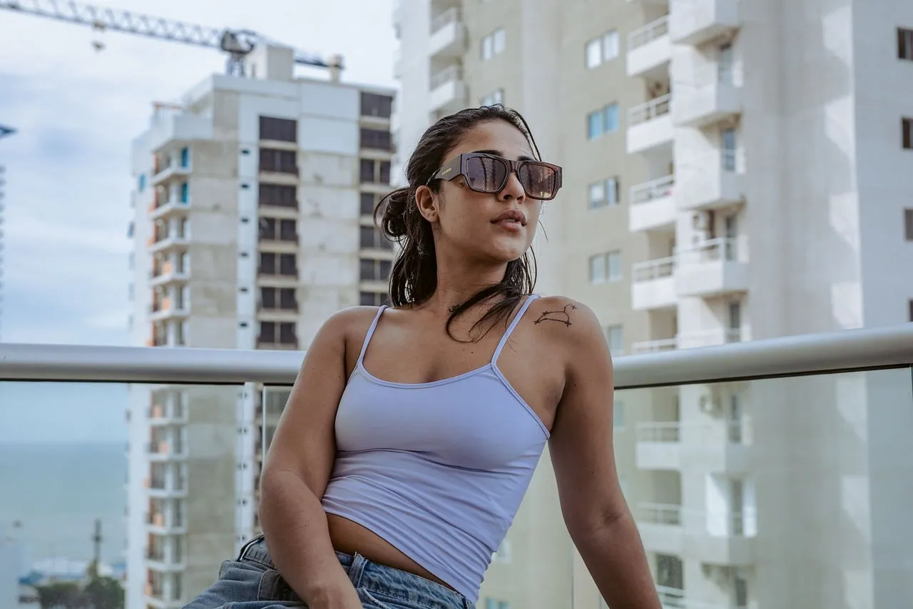 Miami Vibes: Stylish Woman Relaxes on Balcony with Ocean View