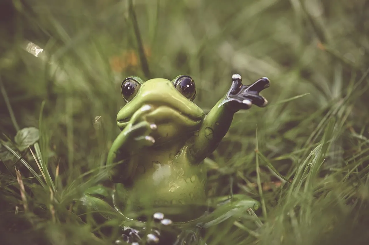 Charming Ceramic Frog Figurine Hiding in Lush Green Grass