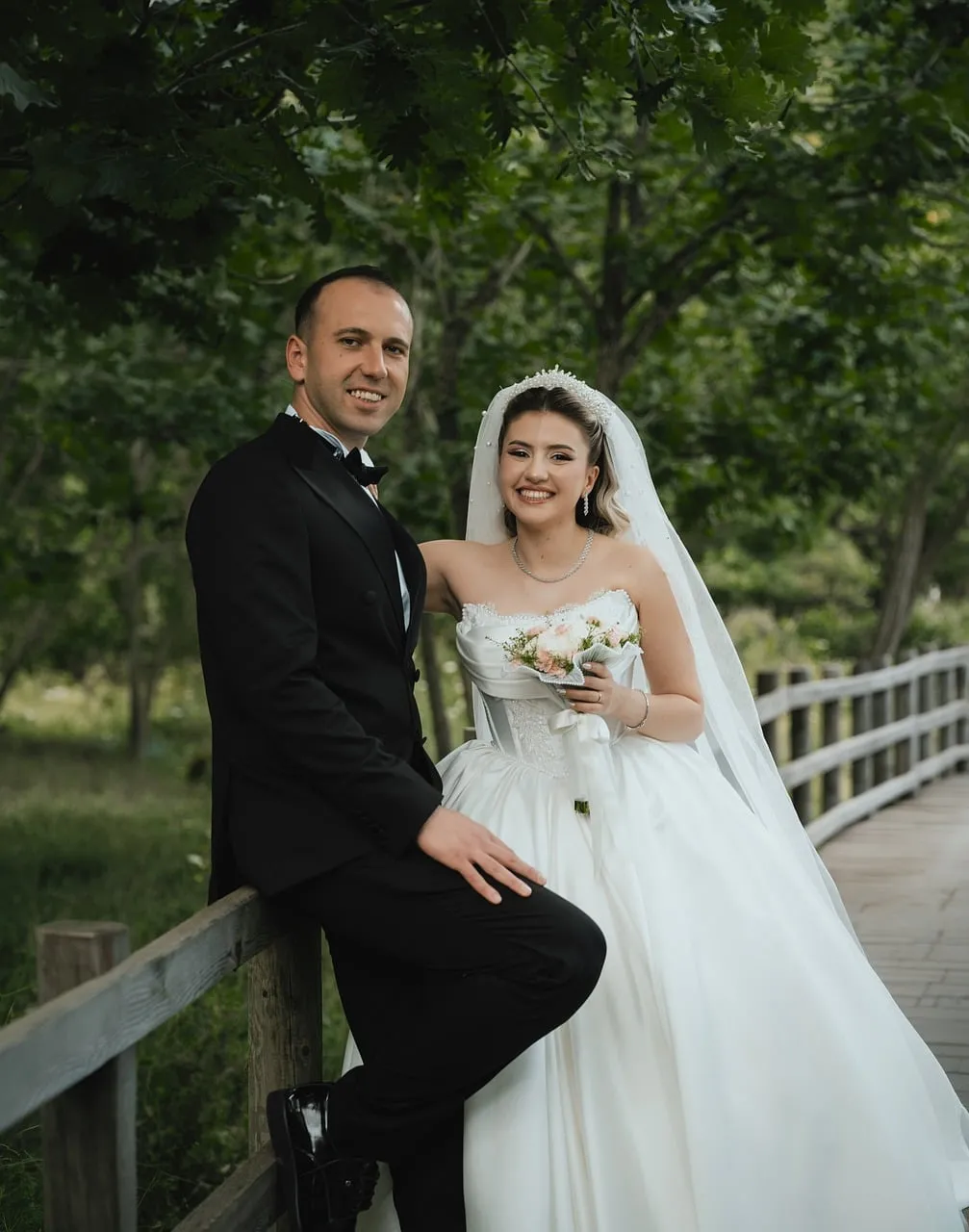 Radiant Love: Bride and Groom on a Rustic Bridge