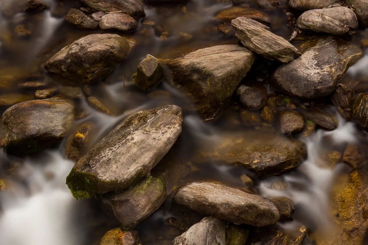 Serene Long Exposure: Misty Autumn River Rocks