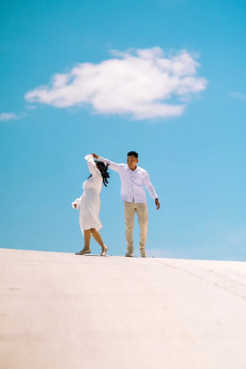 Joyful Couple Dancing Under a Clear Summer Sky