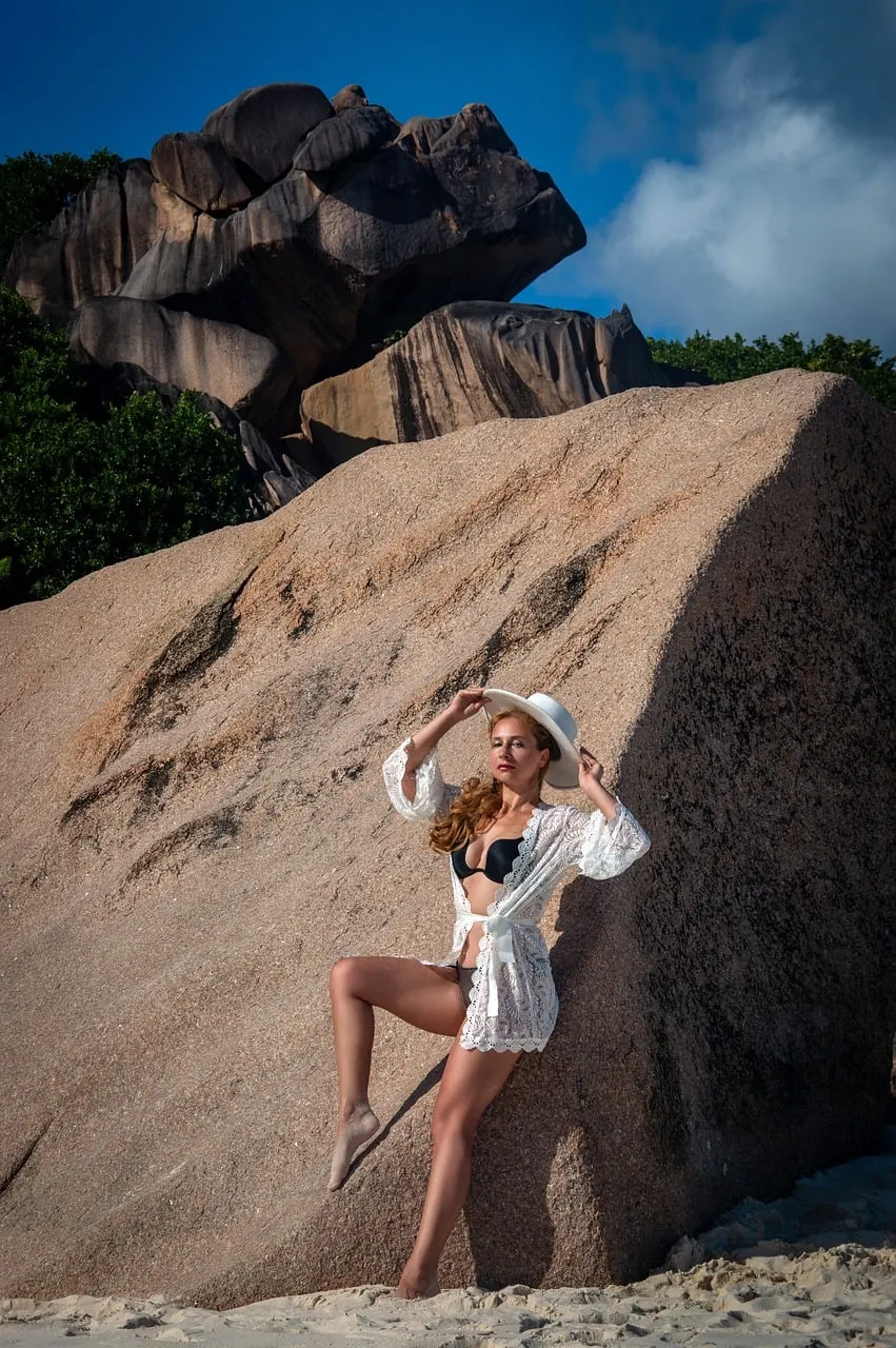 Stunning Beach Siren Poses Against Majestic Rock Formations