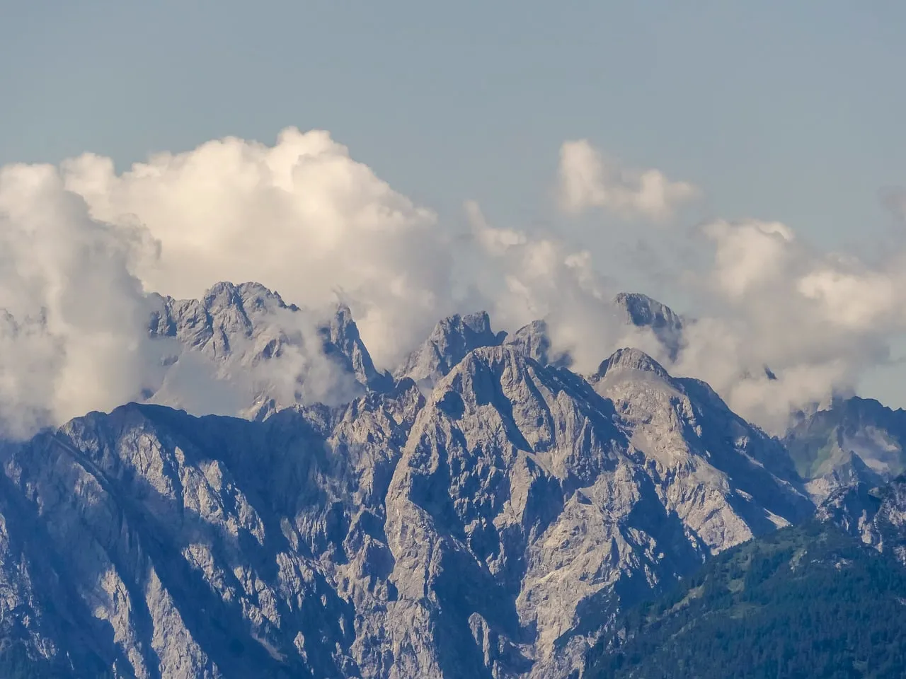 Majestic Alpine Peaks Crowned by Whispering Clouds
