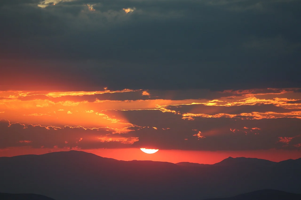 Dramatic Scarlet Sunset over Mountain Silhouettes