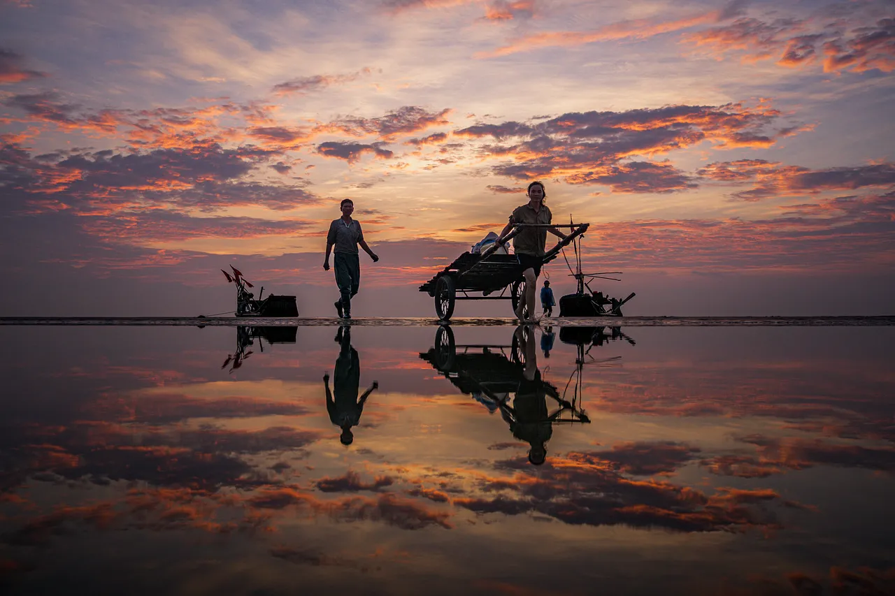 Stunning Dawn: Fishermen Reflected on Vietnam's Beach