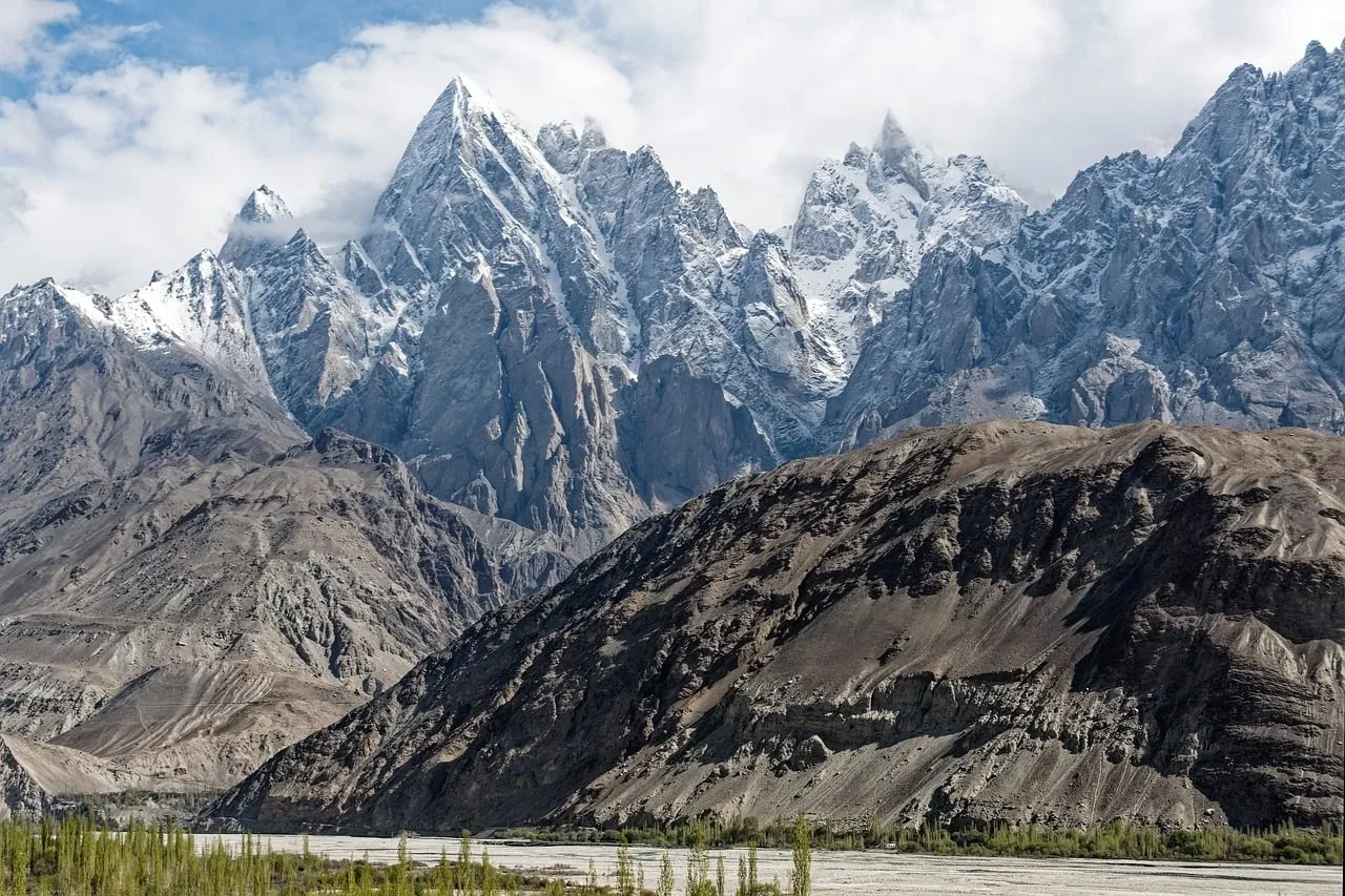 Majestic Karakoram Peaks: Snow-Kissed Giants and Serene River