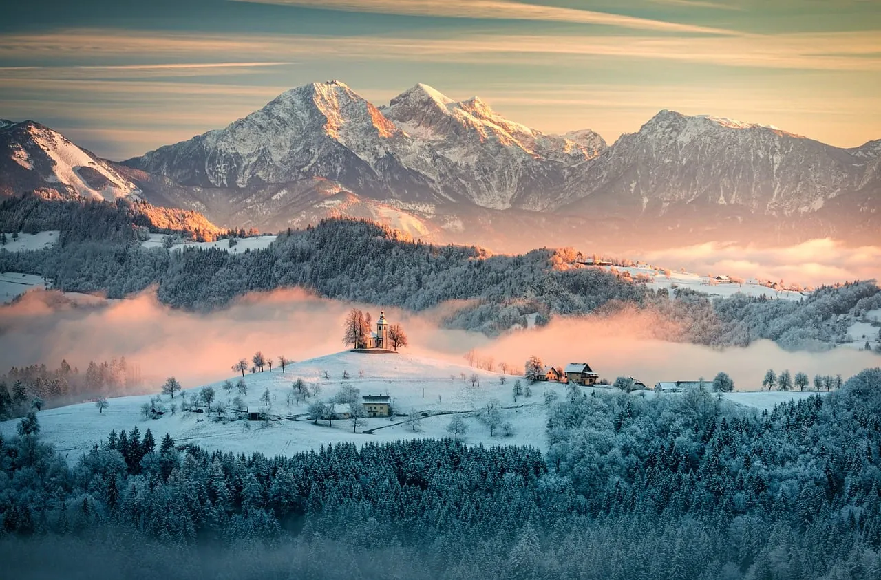 Breathtaking Winter Sunrise: Slovenian Alps' Misty Embrace