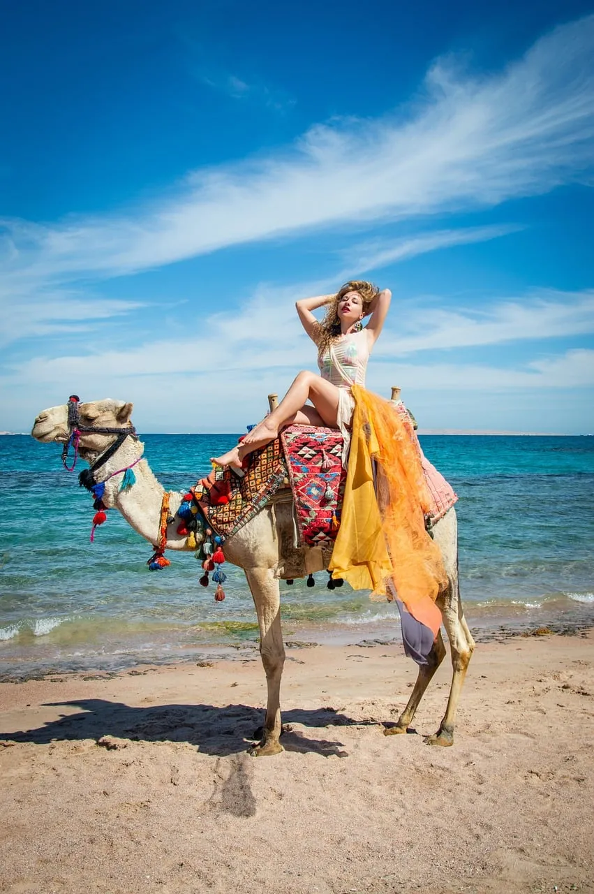 Exotic Beauty: Woman on Camel by the Azure Sea