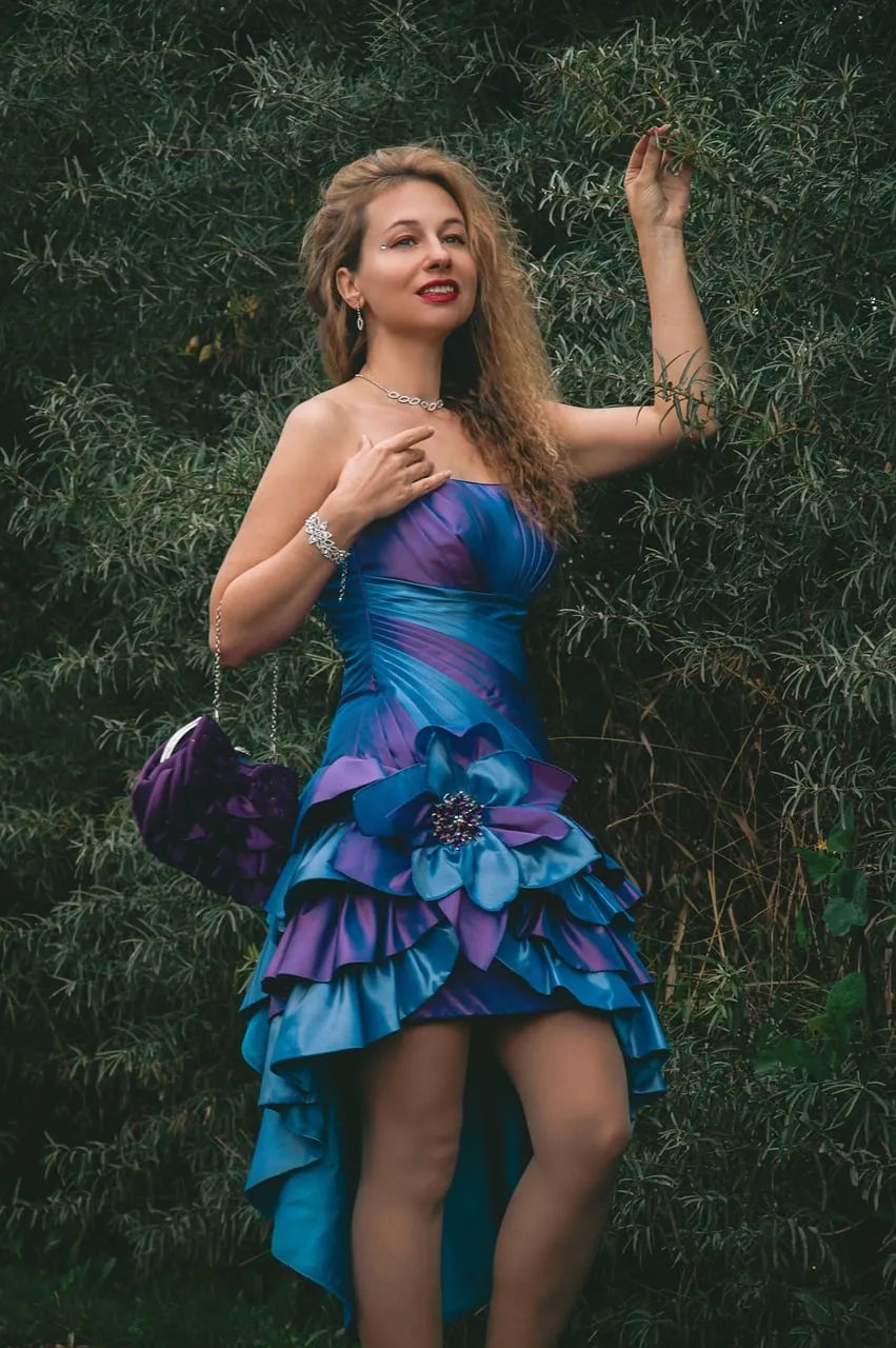 Stunning Elegance: Woman in Purple Evening Gown Amidst Nature's Embrace