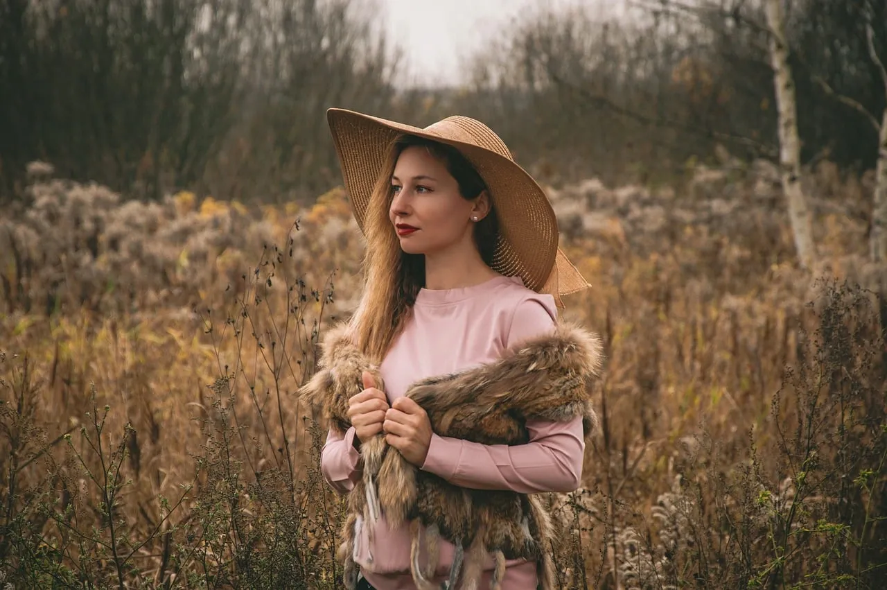 Enchanting Autumn Portrait: Woman in Hat Amidst Golden Fields