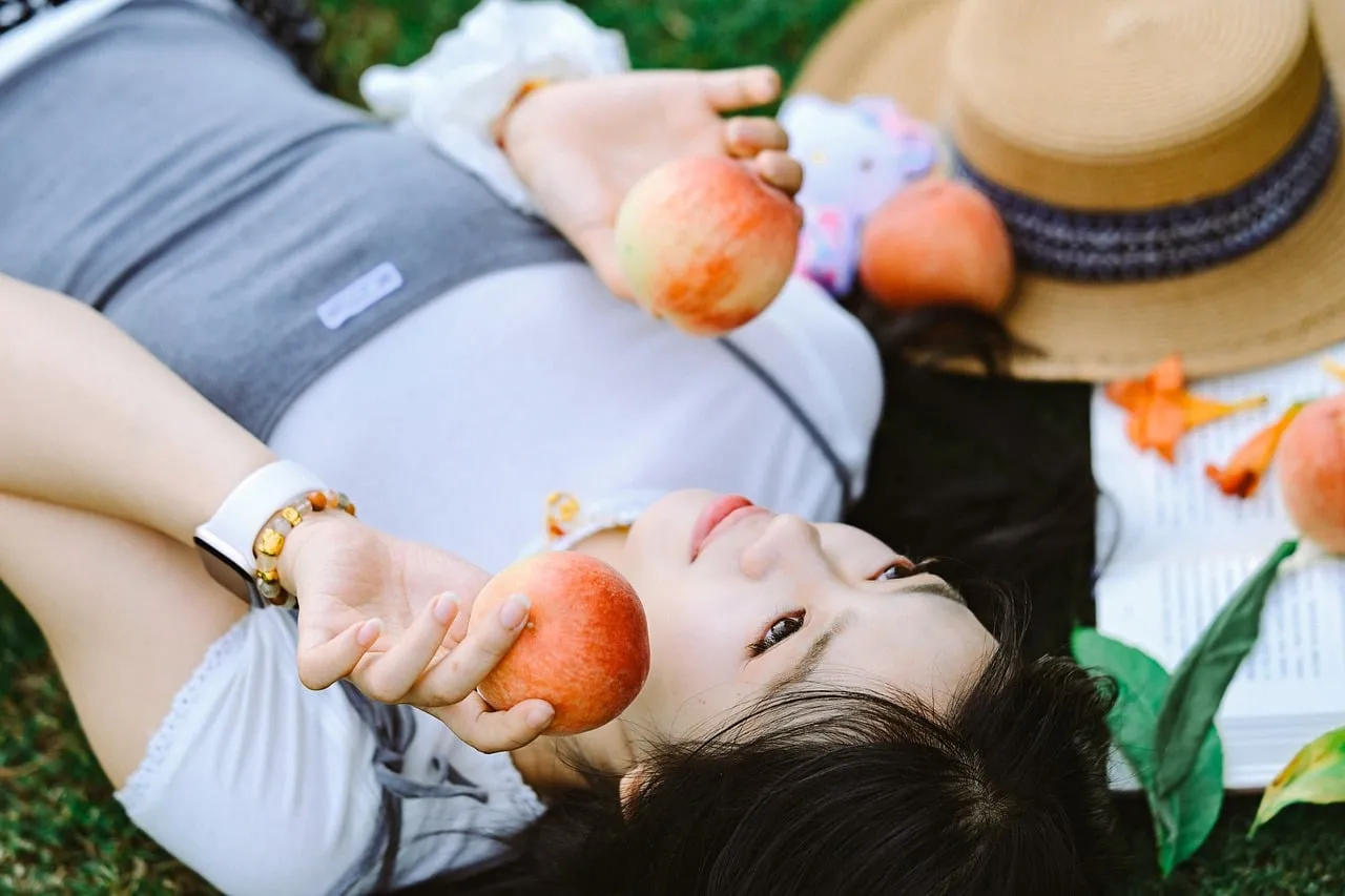 Serene Summer Escape: Woman Relaxing with Peaches in Nature