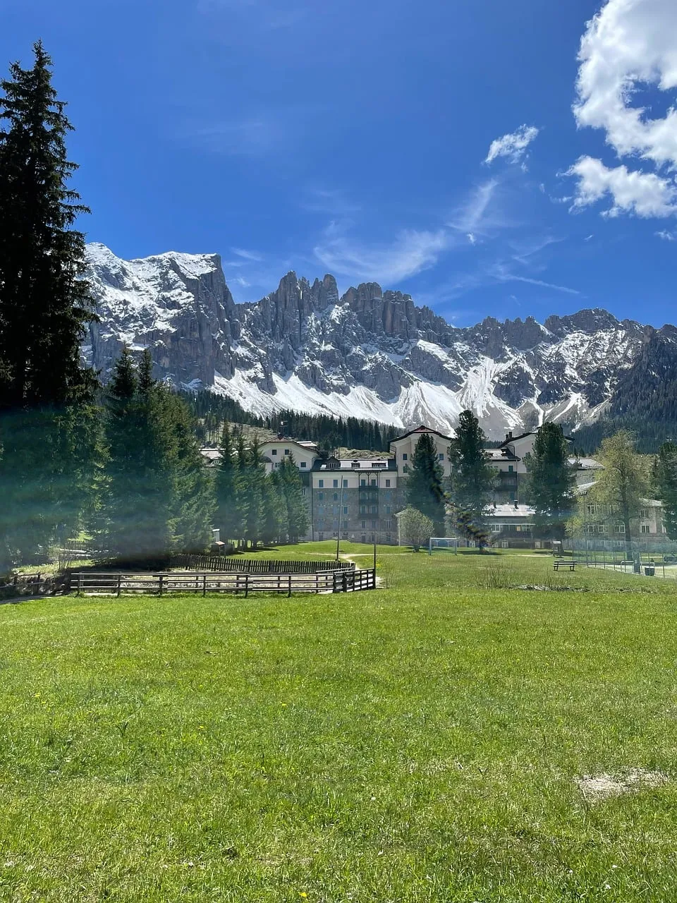 Majestic Alpine Vista: Serene Cottages Amidst Snow-Capped Peaks