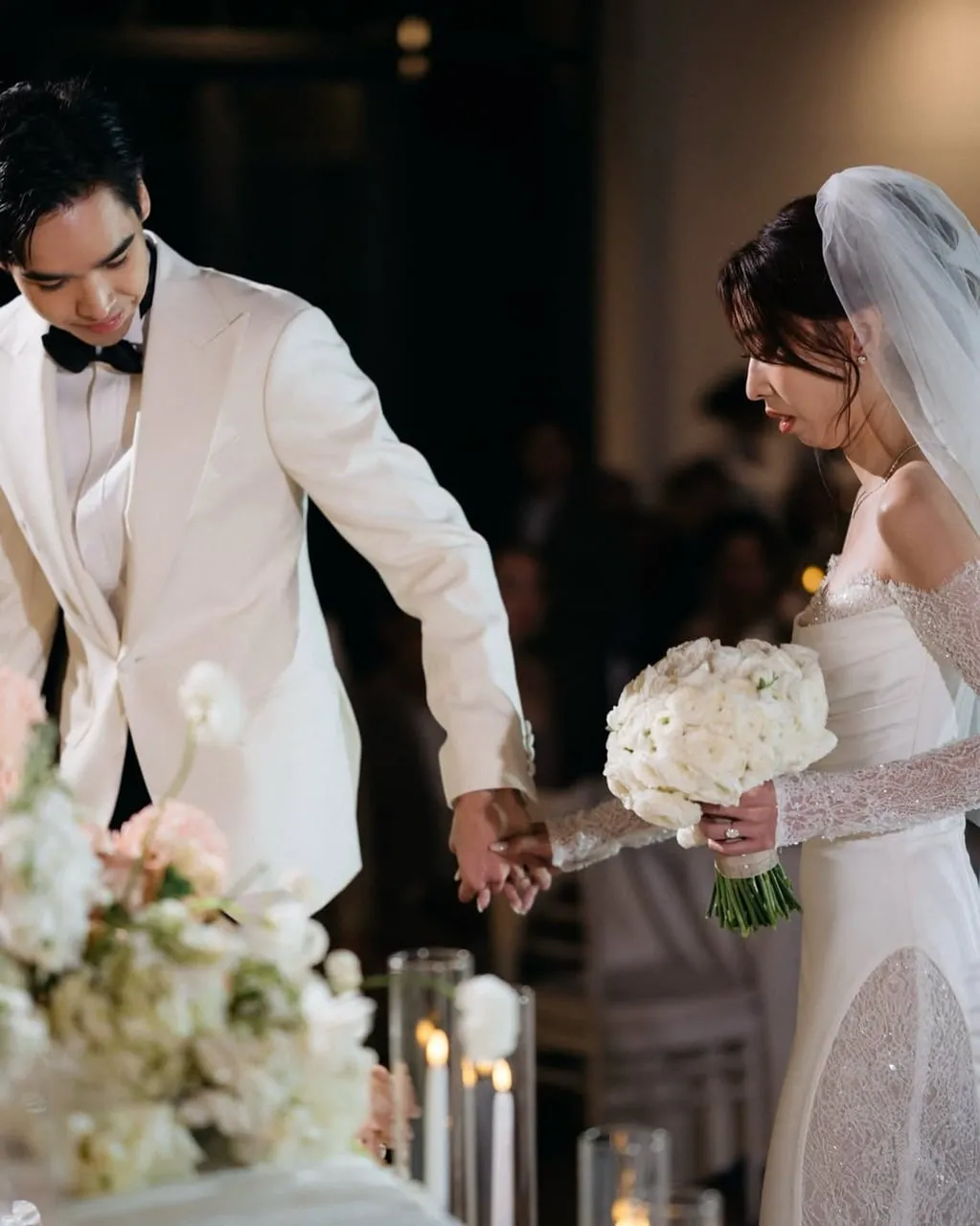 Elegant Wedding Moment: Bride and Groom Hand in Hand