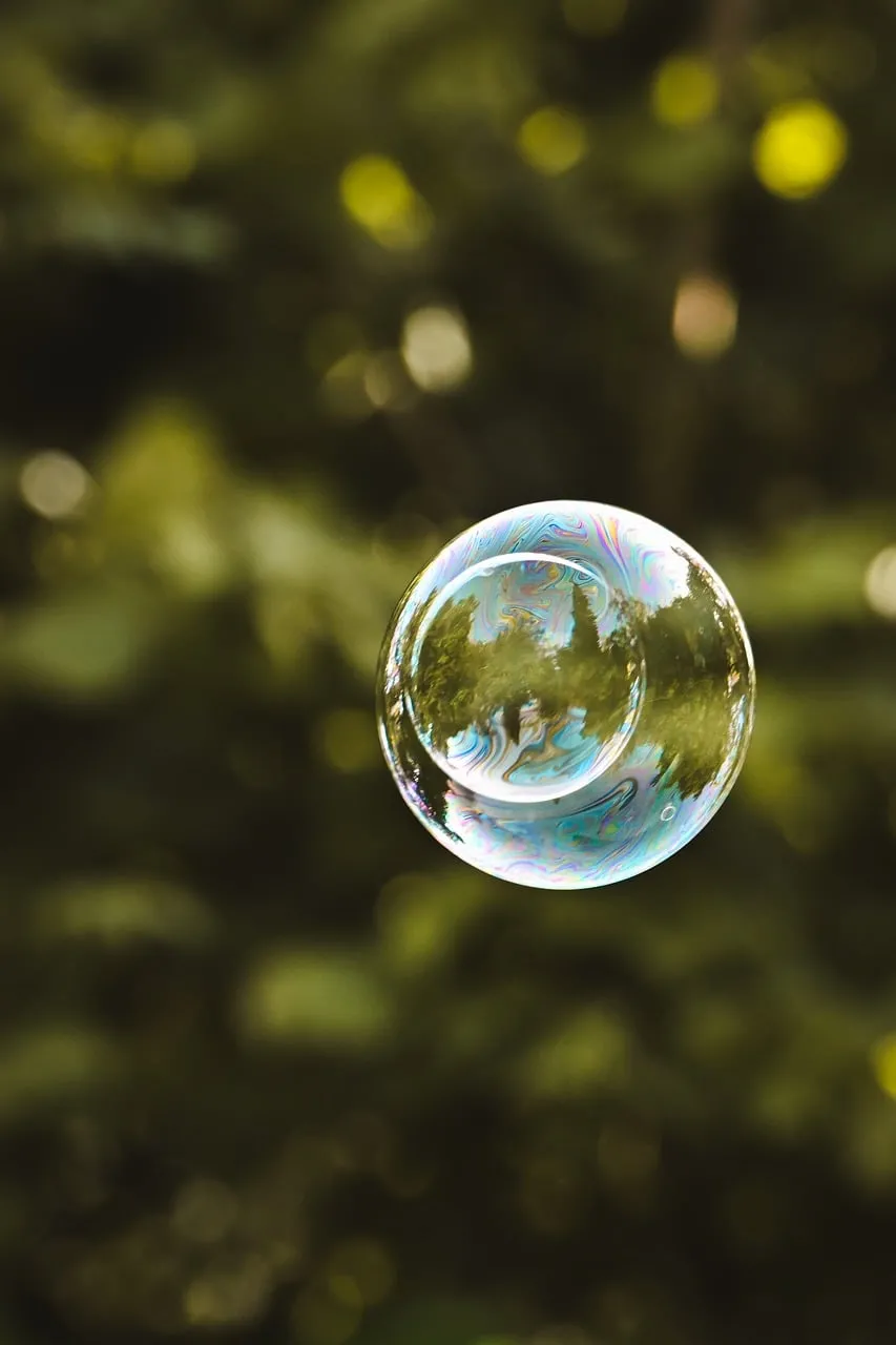 Enchanting Rainbow Bubble Floating in Green Serenity