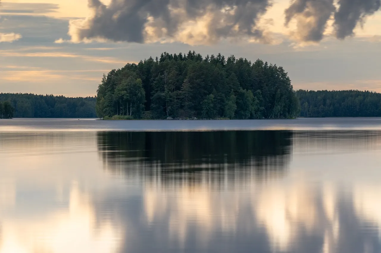 Serene Sunset Reflection: Tranquil Finnish Lake Landscape