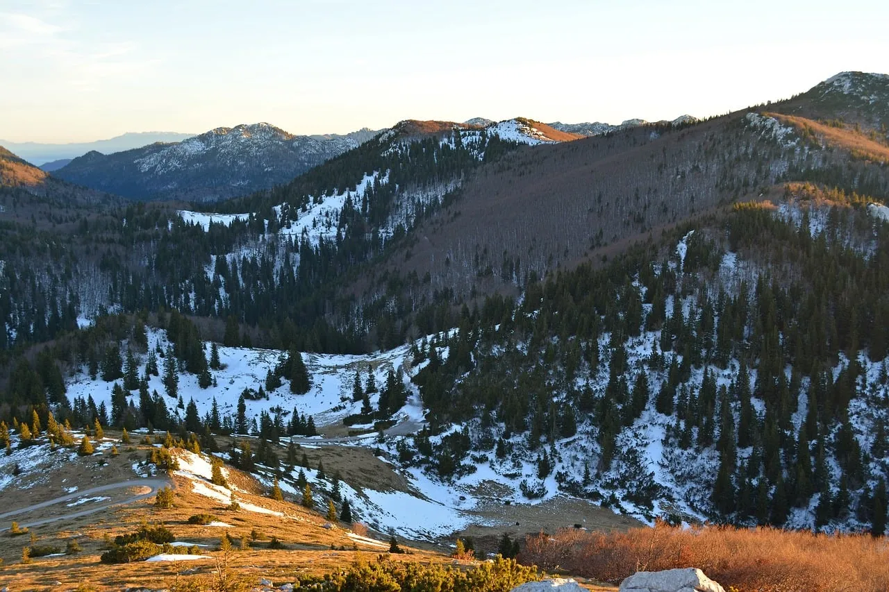 Dramatic Winter Sunset Bathes Velebit's Snowy Peaks in Golden Light
