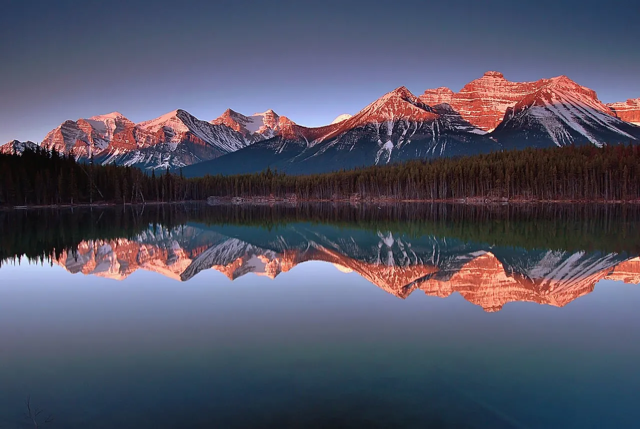 Breathtaking Alpenglow: Herbert Lake's Mirrored Mountain Majesty