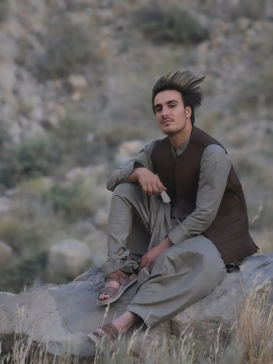 Striking Portrait: Man in Traditional Attire Amidst Nature