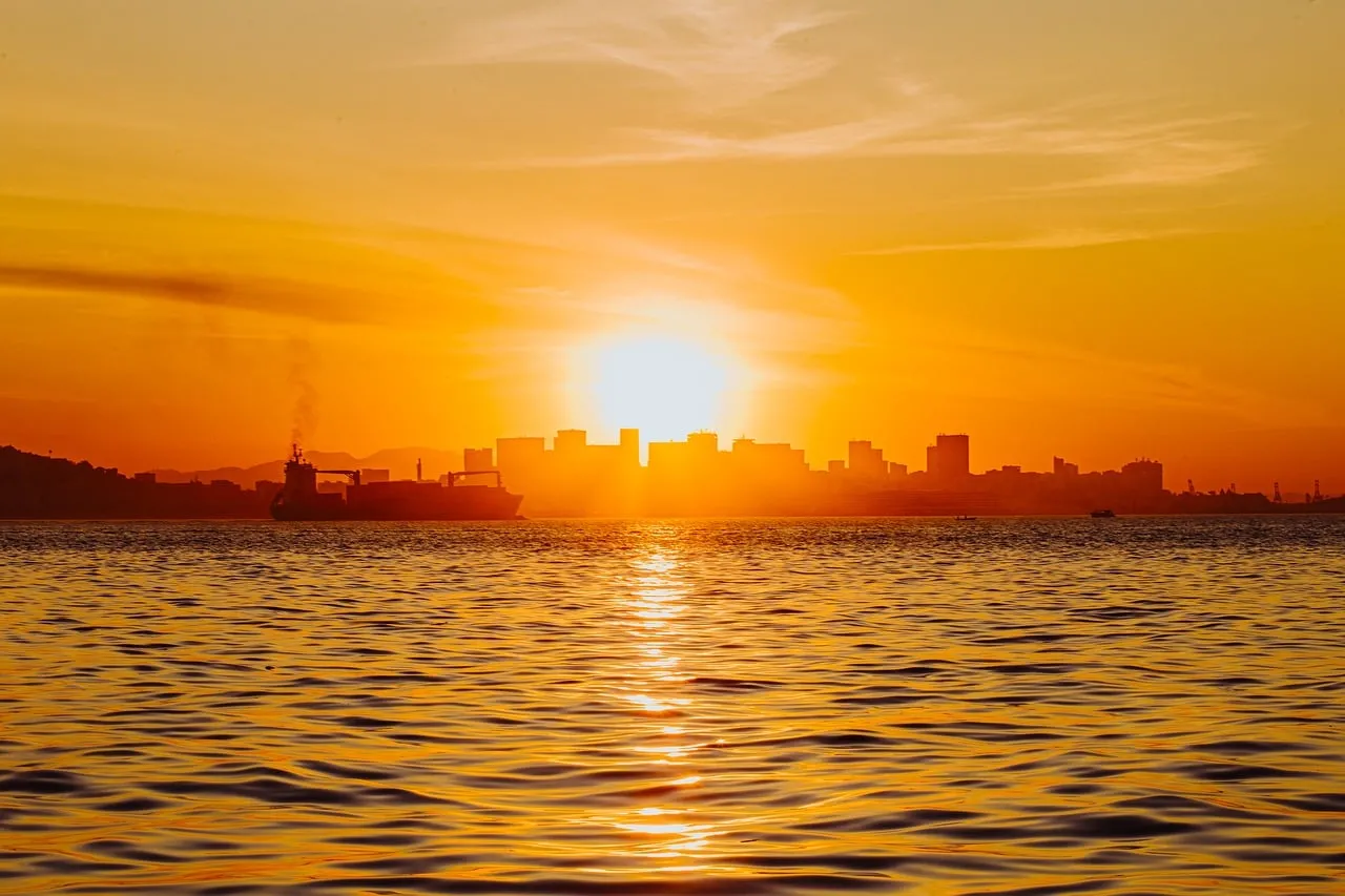 Fiery Brazilian Sunset: City Skyline Silhouetted by Golden Hues
