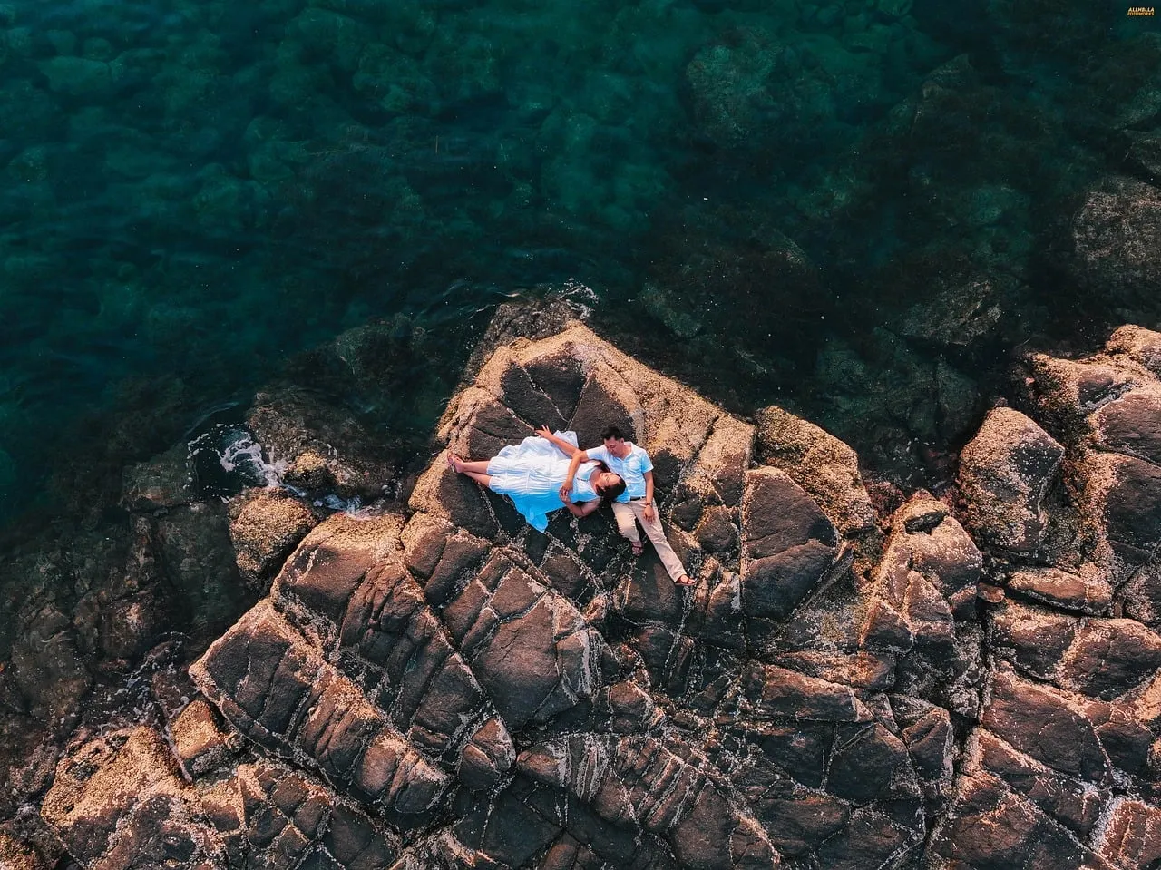 Breathtaking Drone View: Romantic Couple on Rocky Beach