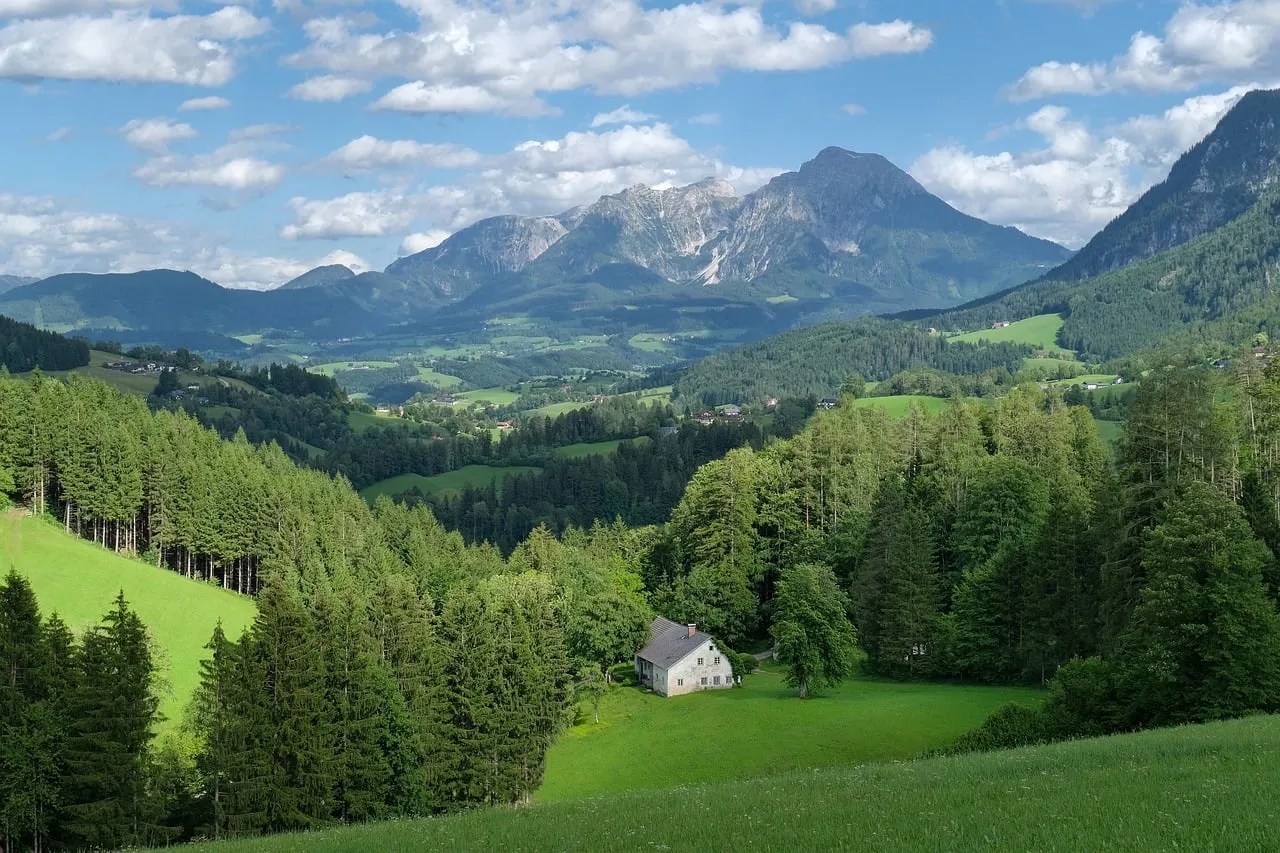 Majestic Alpine Panorama: Secluded Cabin Amidst Verdant Valleys