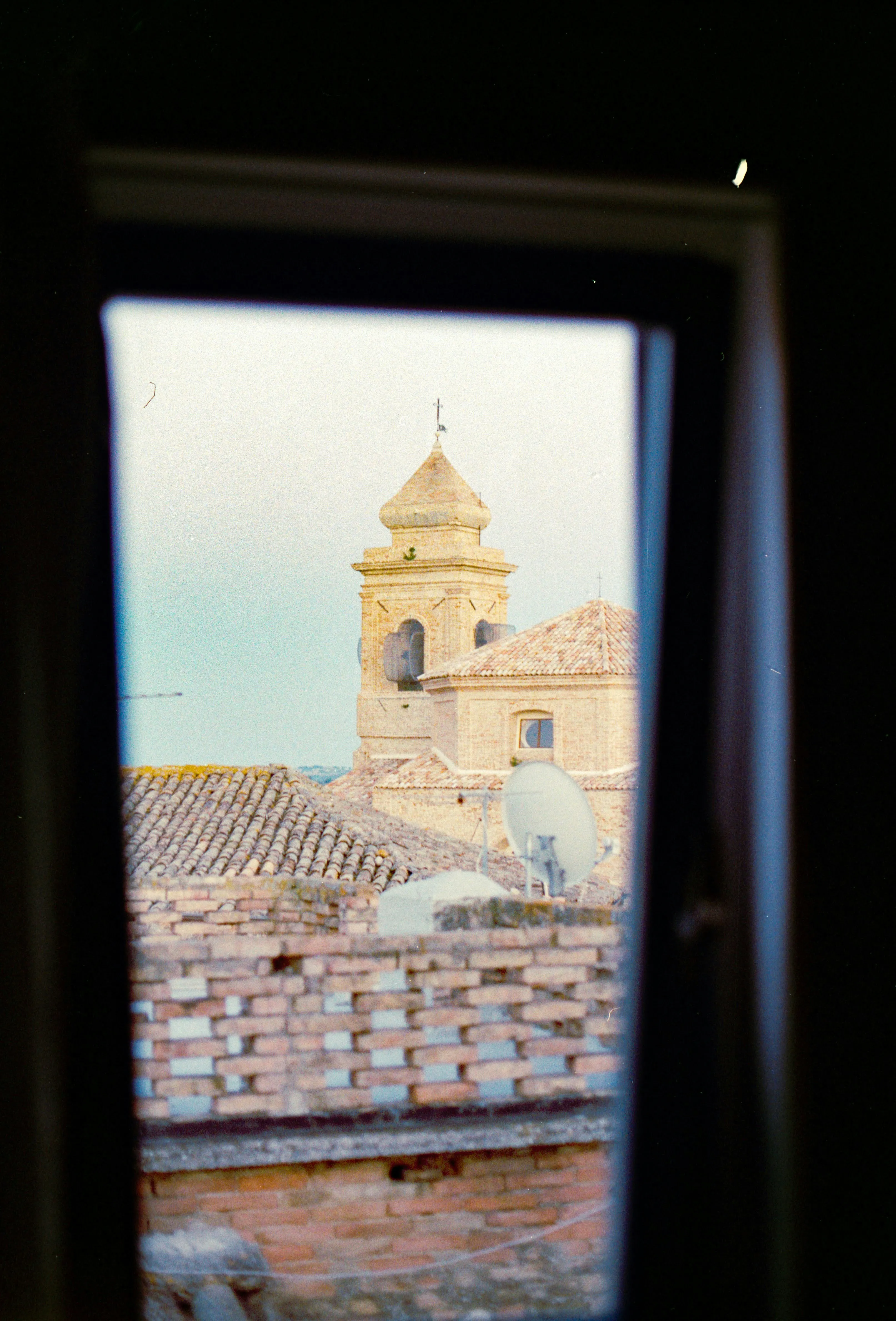 Charming Church Tower View Through a Rustic Window Frame