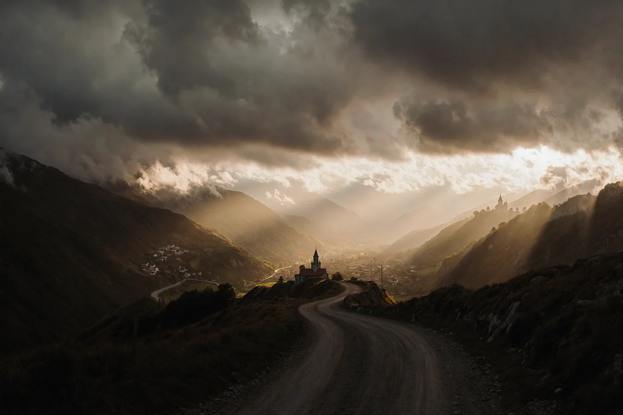 Dramatic Sunset Over Winding Mountain Valley with Church
