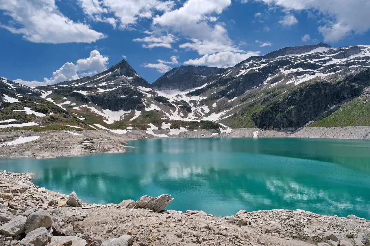 Breathtaking Alps: Turquoise Lake Amidst Snowy Peaks