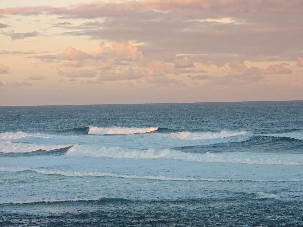 Serene Coastal Sunset: Waves Kissing the Horizon