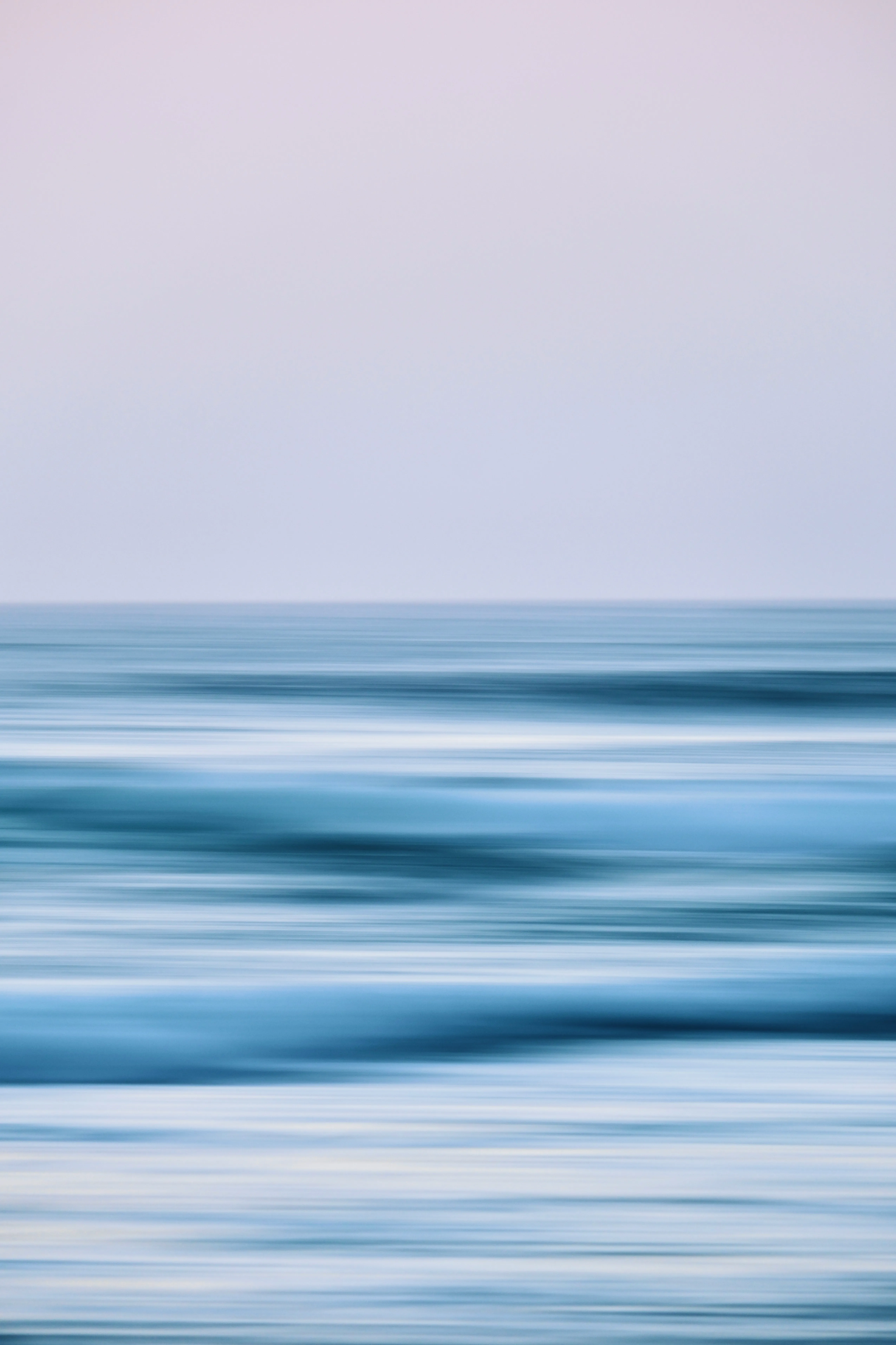 Hypnotic Horizon: Abstract Ocean Waves Meet Pale Sky
